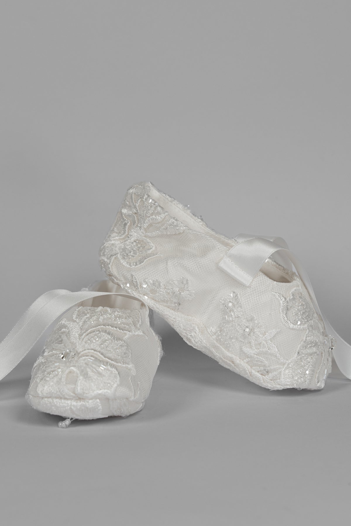 My Blessing ivory christening shoes with lace detailing embellished with sequins, glass seed beads, and Swarovski crystal beadwork from the Elora set.