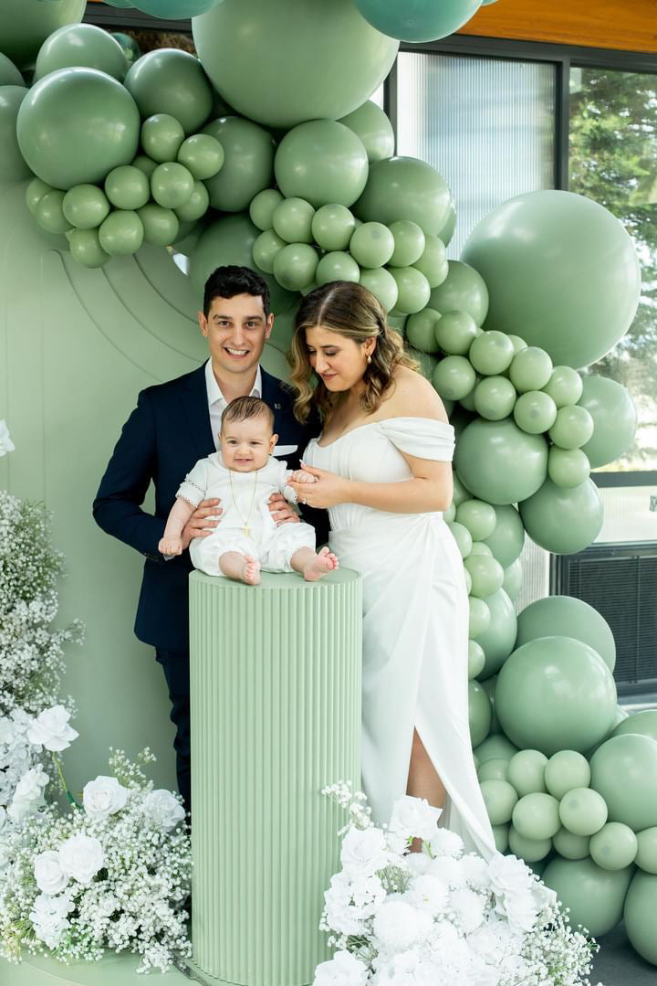 Baby boy wearing the My Blessing Georgie Mikado christening romper laughing joyfully, the smooth fabric adding elegance to the playful moment.
