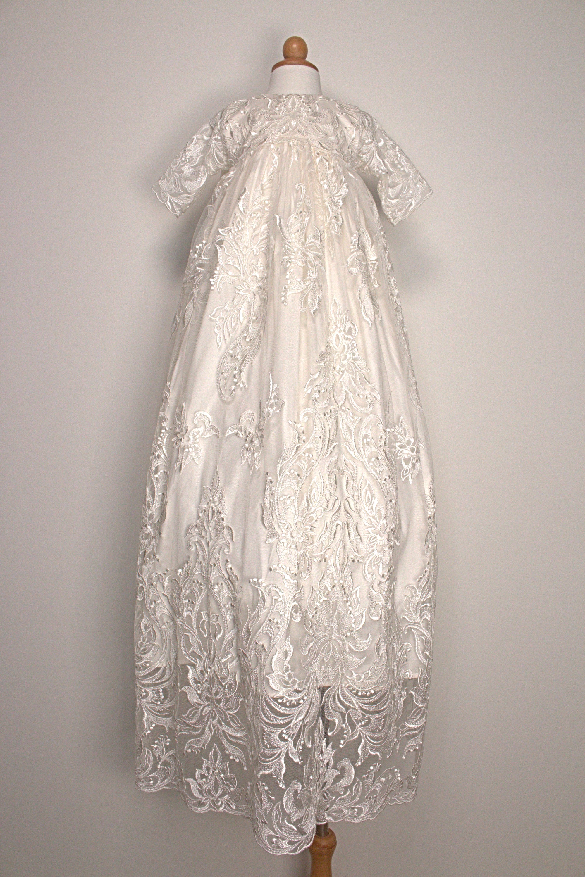 My Blessing Glorious ivory christening gown featuring an embroidered lace bodice, short sleeves, and a flowing satin skirt.