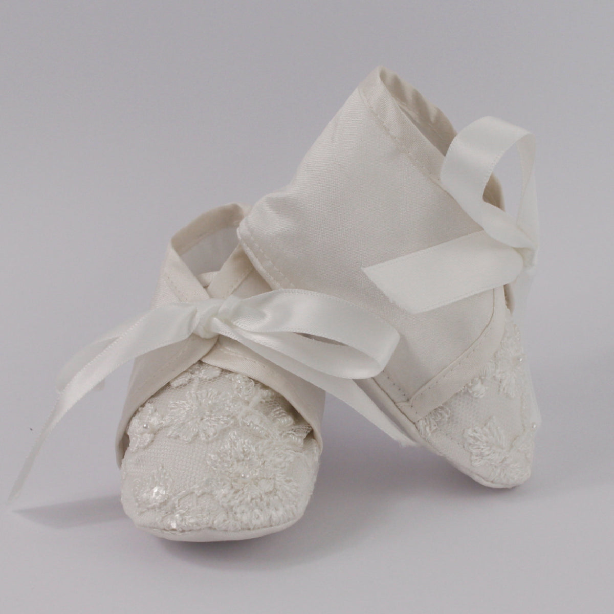 My Blessing ivory christening shoes from the Humble set featuring European lace detailing with hand‑finished pearls, beads, and sequins.