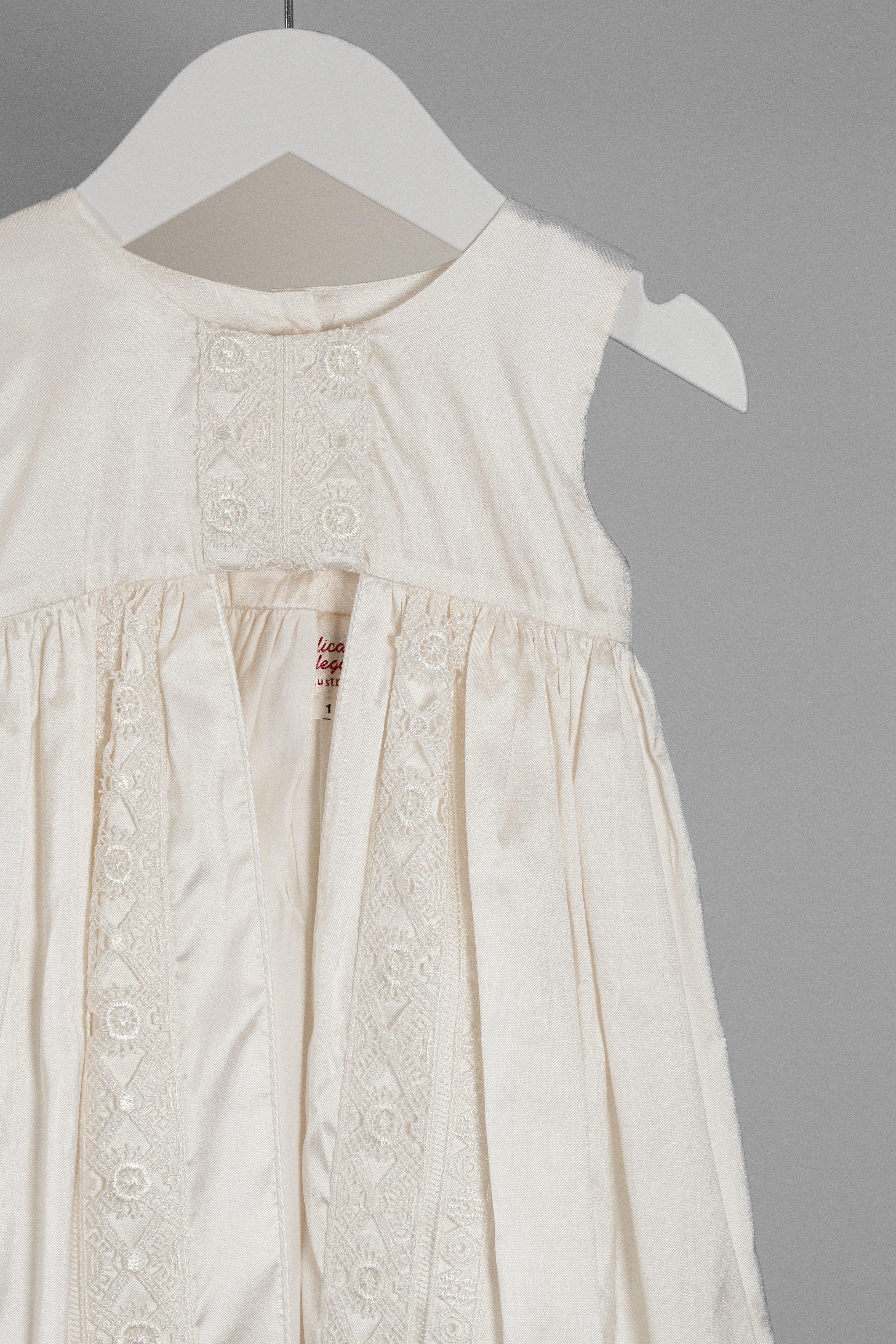 Close-up of the Lael cape showing the smooth Dupioni silk texture and refined stitching.