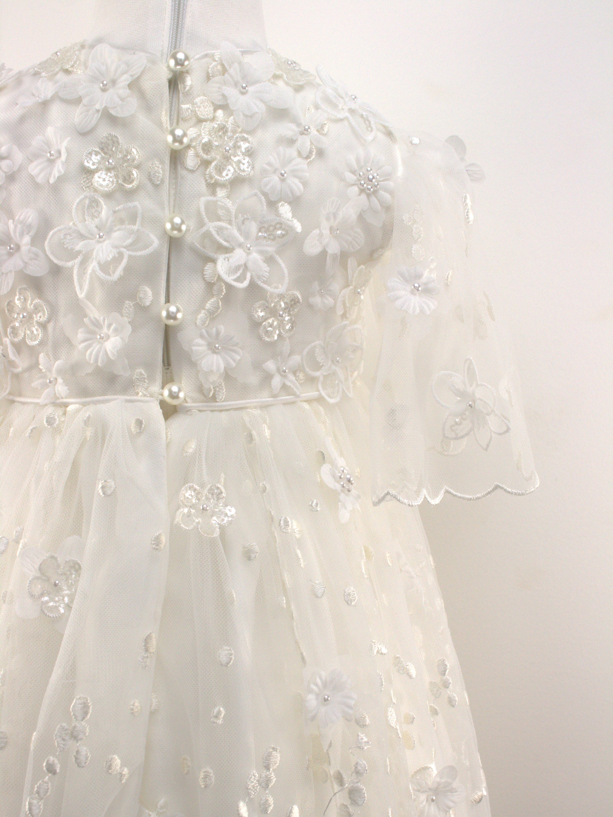 Close-up of the My Blessing Nahren gown’s back bodice featuring delicate lace patterns and button or tie closures.
