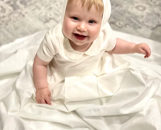 My Blessing ivory full‑length Noa christening gown made from soft premium linen, featuring a classic Peter Pan collar and two front pleats.
