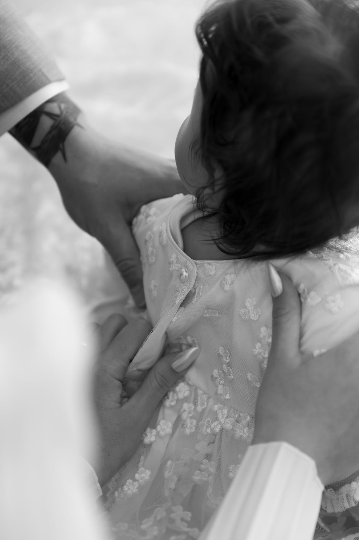 Close-up of the My Blessing Promise gown’s back bodice featuring European lace with lossy pearly button closure.