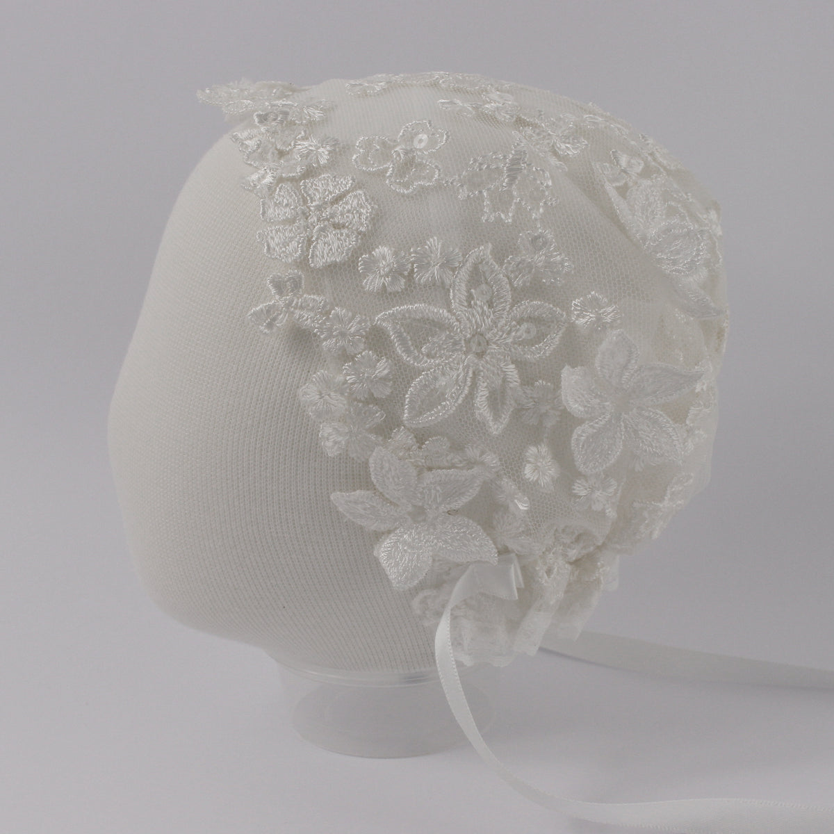 Ivory christening bonnet from the My Blessing Promise set featuring European floral lace with delicate glass seed bead accents.