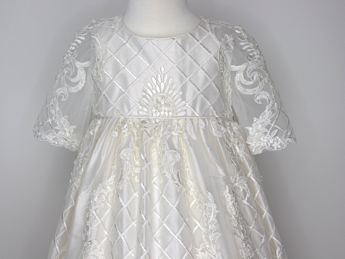 Close-up of the My Blessing Psalms gown’s back bodice featuring delicate lace patterns decorated with glass seed beads and pearls.