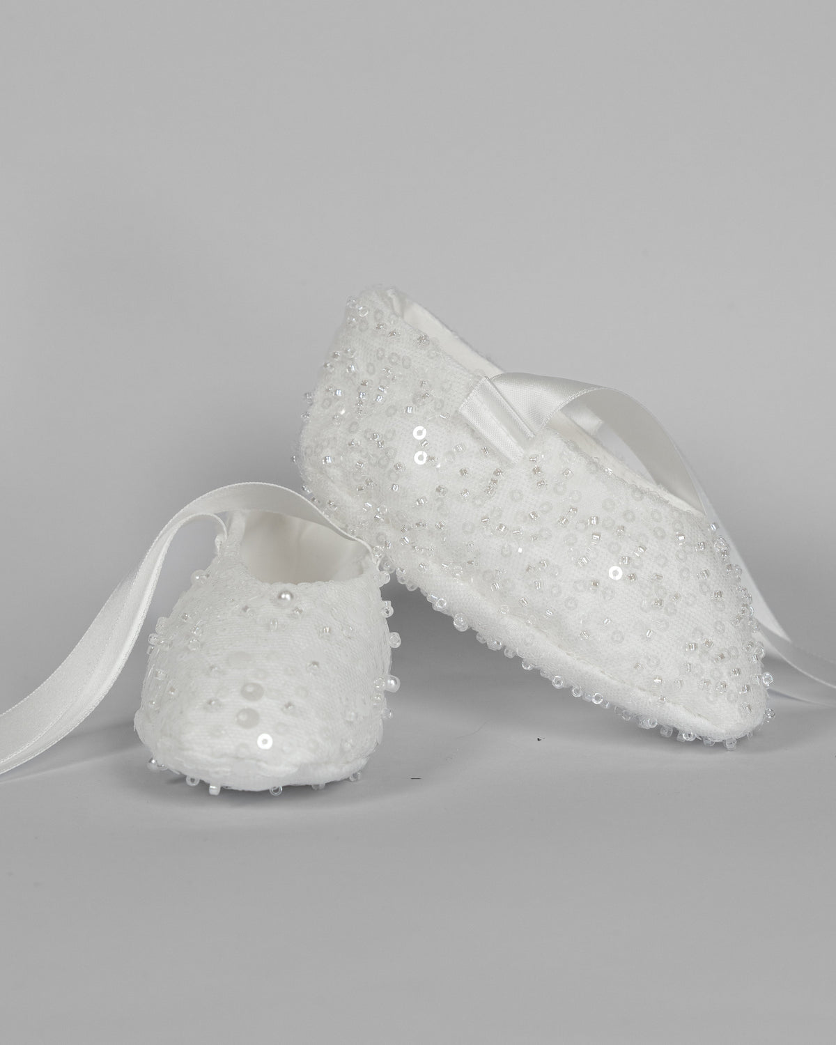 My Blessing ivory christening shoes with lace detailing embellished with sequins, glass seed beads, and miniature pearls from the Ruth set.
