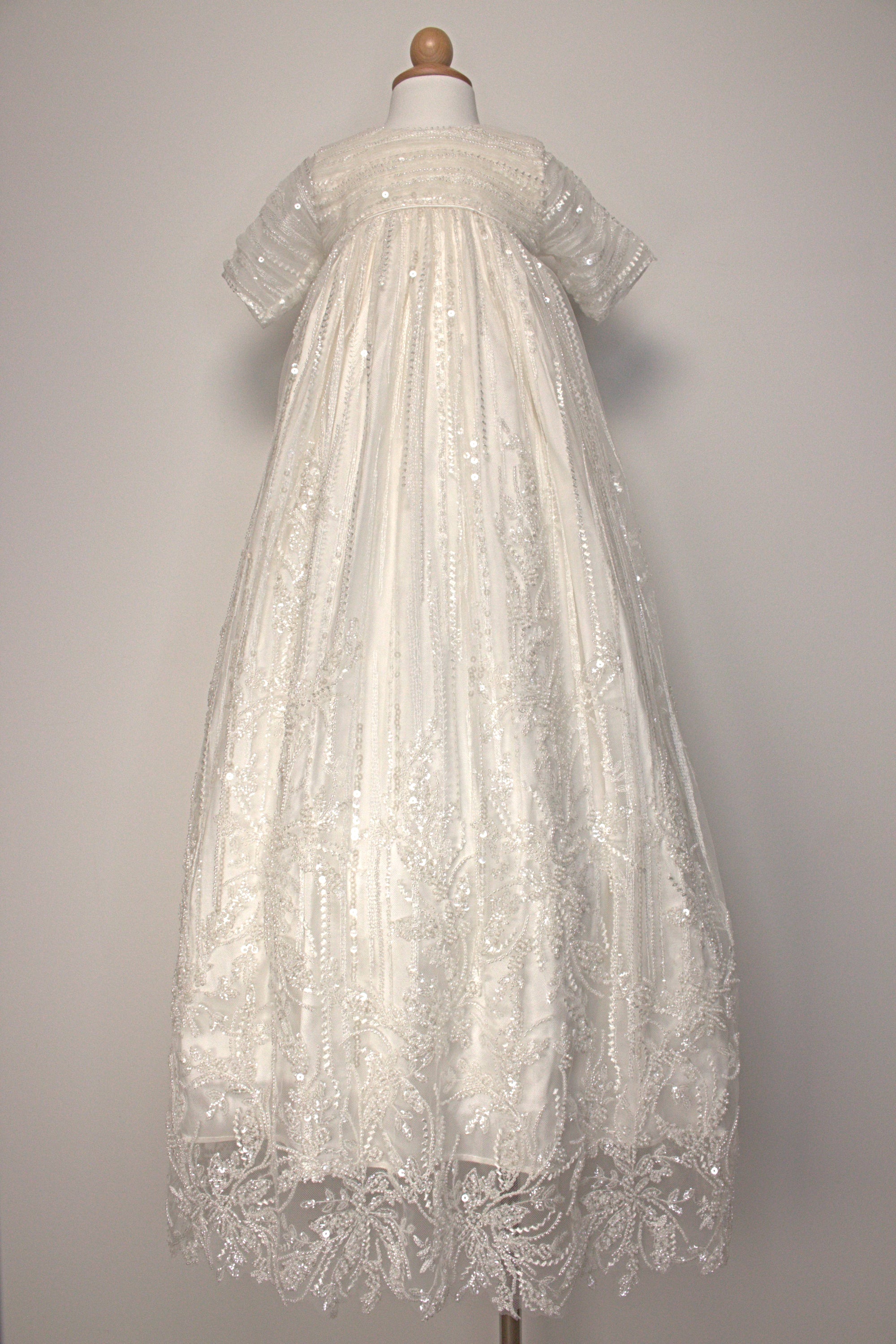 My Blessing Soul ivory christening gown featuring an embroidered lace bodice, short sleeves, and a flowing satin skirt.