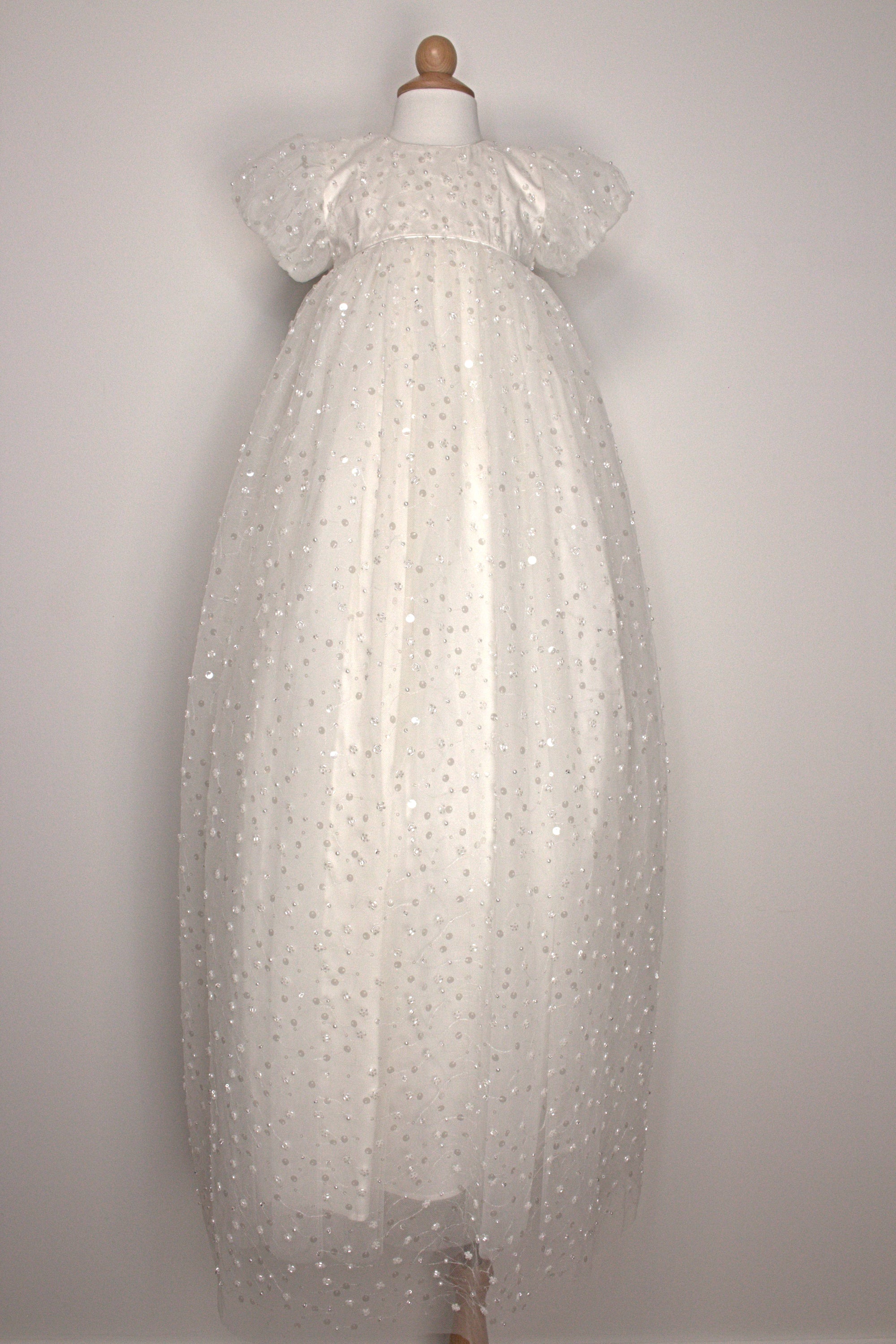 My Blessing Strength ivory christening gown back view showing lace detailing, back closures, and the smooth satin skirt.