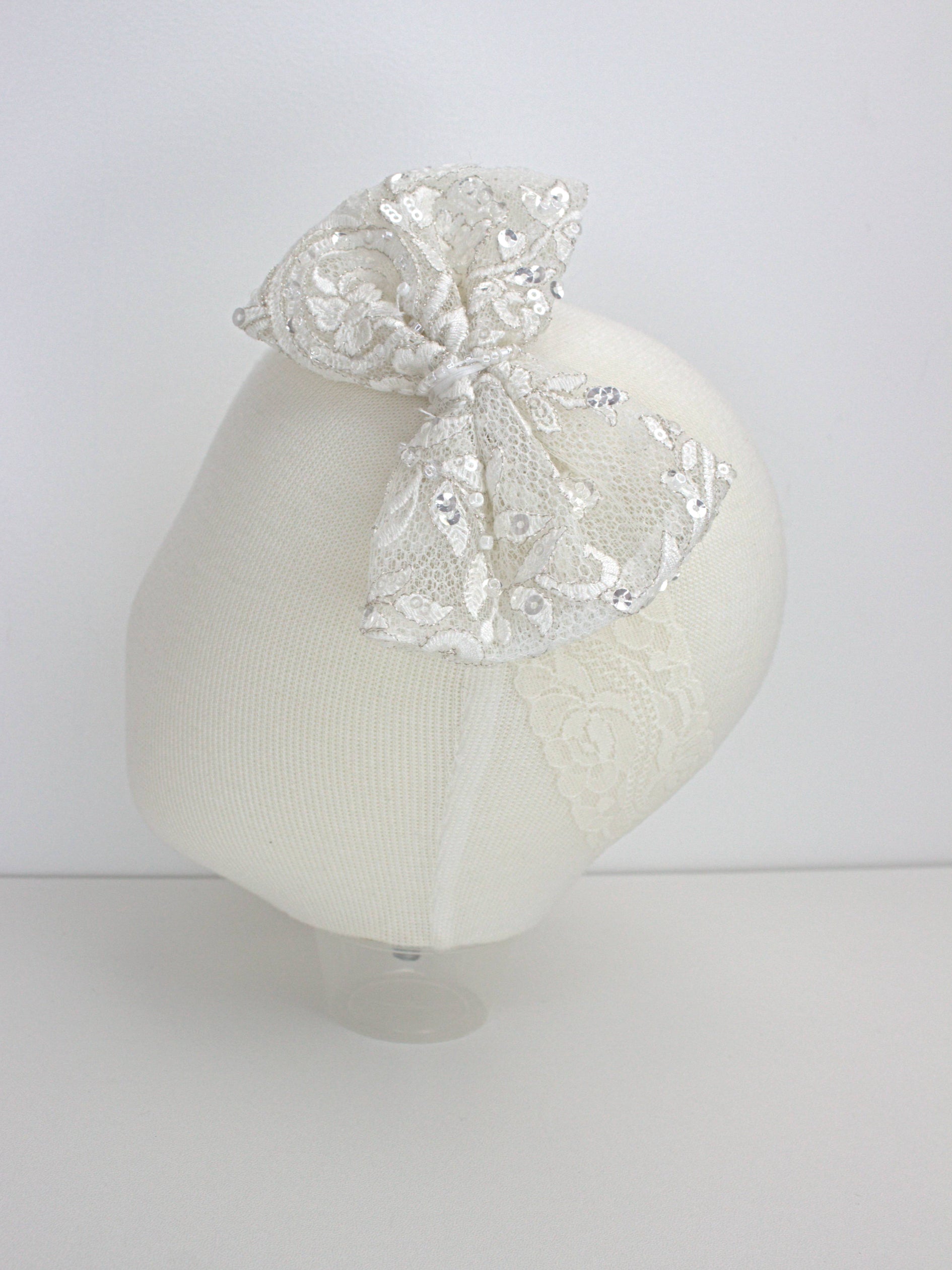 My Blessing ivory baby headband with a lace flower embellishment from the Wholesome christening set.