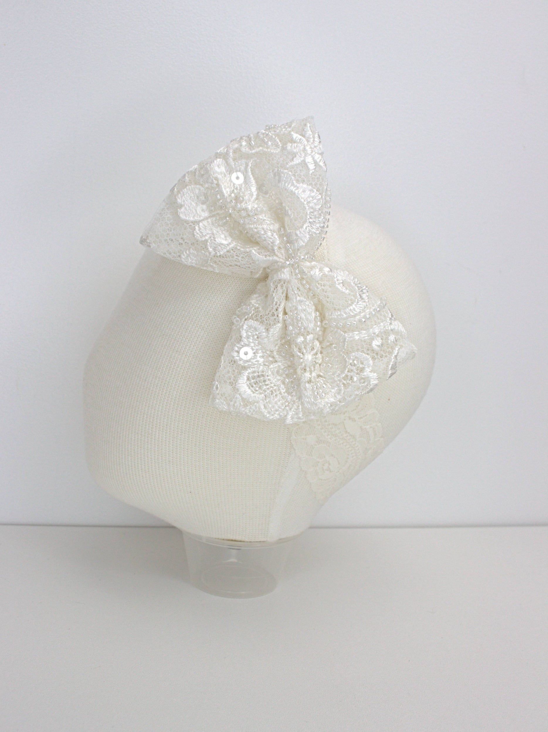 My Blessing ivory baby headband with a lace flower embellishment from the Worthy christening set.