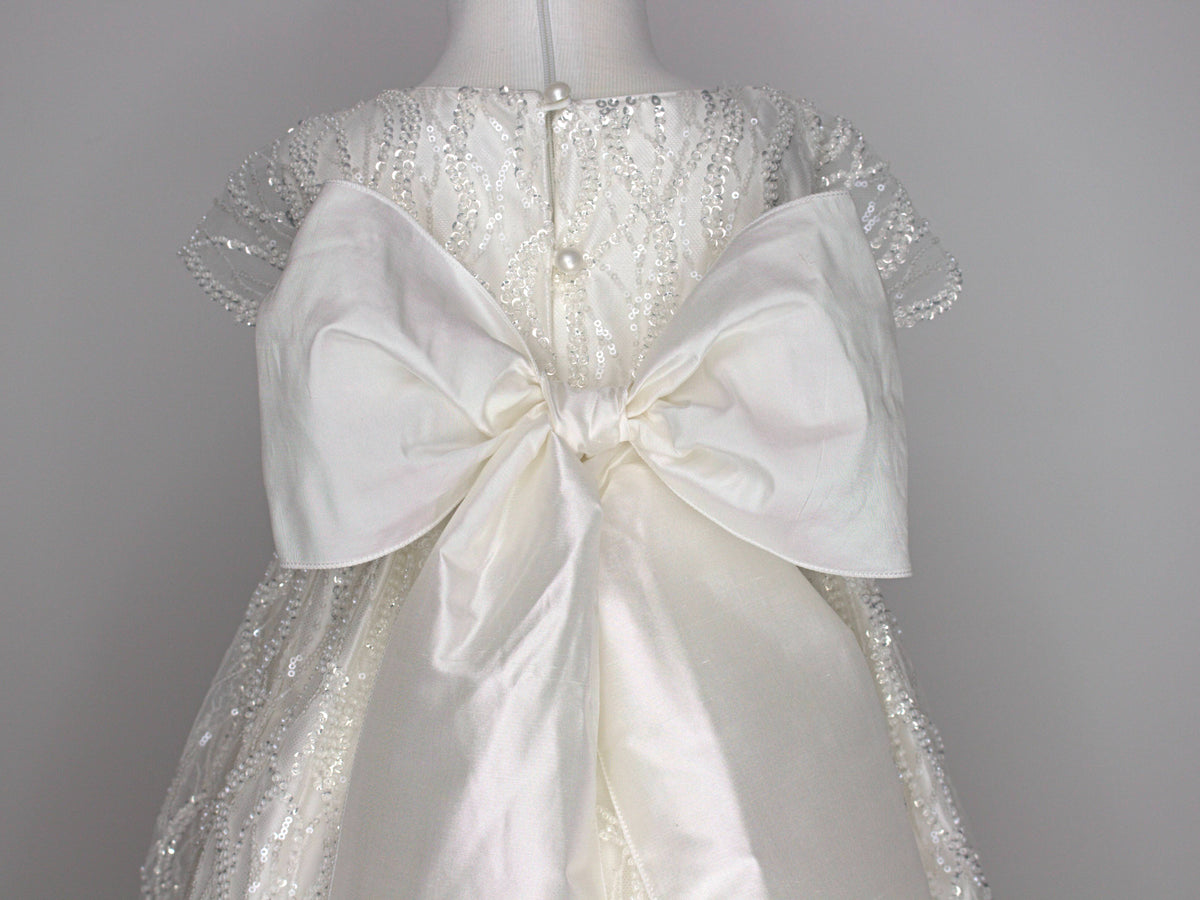 Close-up of the My Blessing Zuriel gown’s back bodice featuring delicate lace patterns embellished with reflective sequins and glass seed beads.