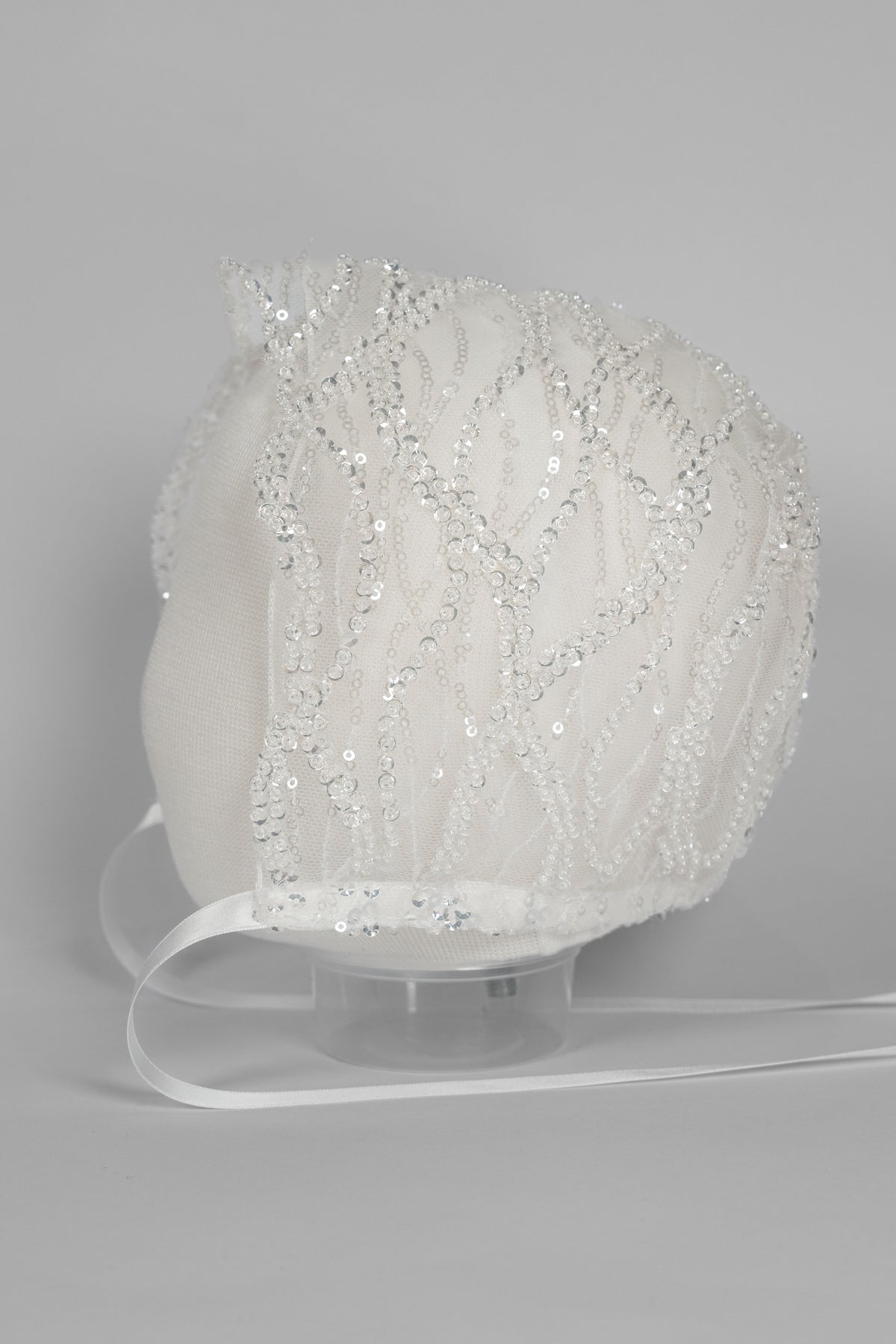 My Blessing ivory christening bonnet from the Zuriel set with embroidered lace and embellishments of reflective sequins and glass seed beads.