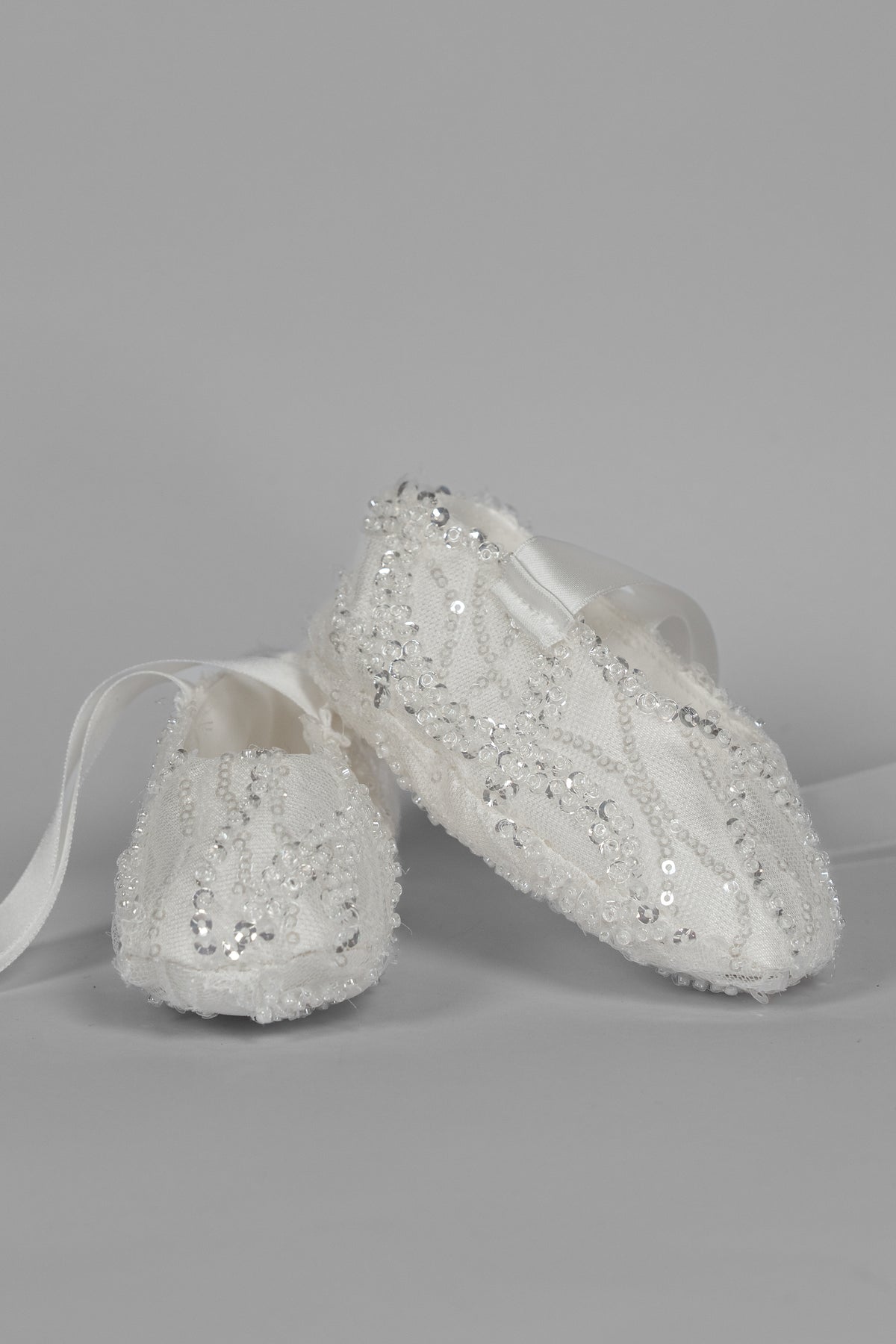 My Blessing ivory christening shoes with lace detailing embellished with reflective sequins and glass seed beads from the Zuriel set.