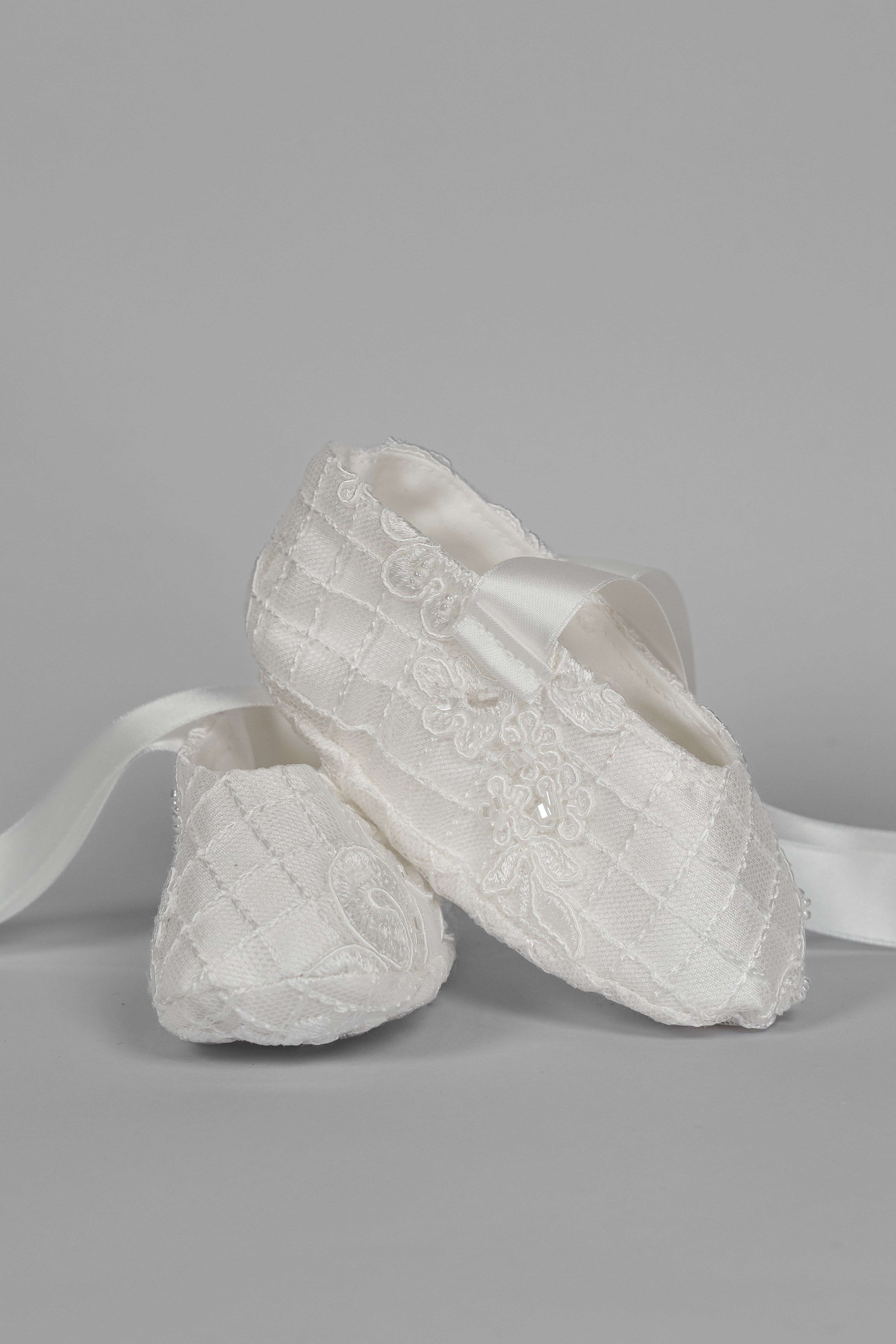 My Blessing ivory christening shoes with satin bows and matching lace detailing from the Bithiah set.