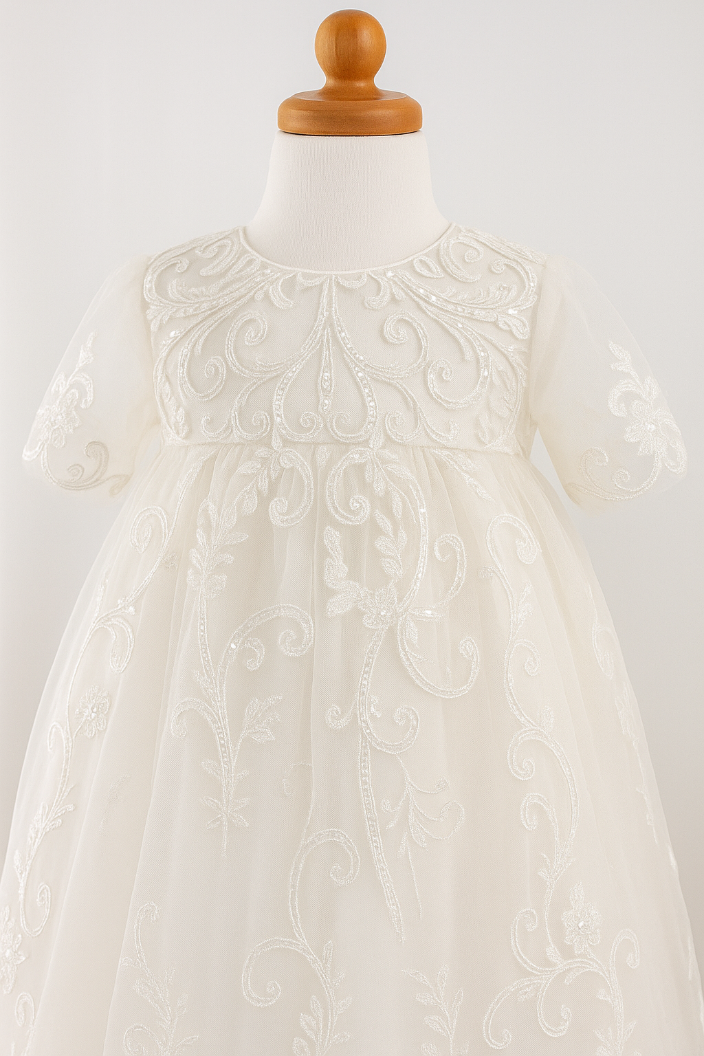 Close-up of the My Blessing Calm christening gown’s front bodice showing detailed floral lace and bead embroidery.