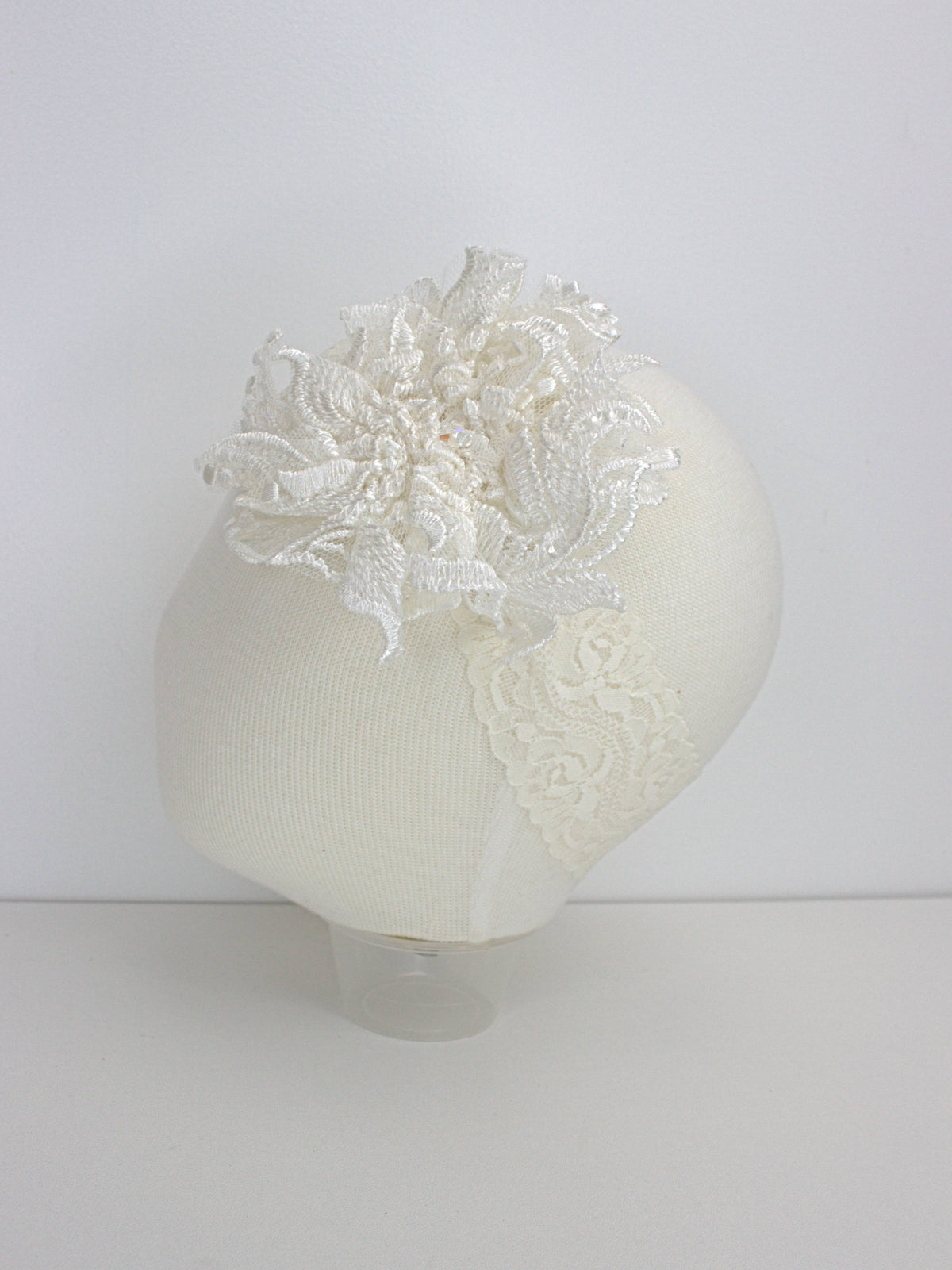 My Blessing ivory baby headband with a lace flower embellishment from the Divine christening set.