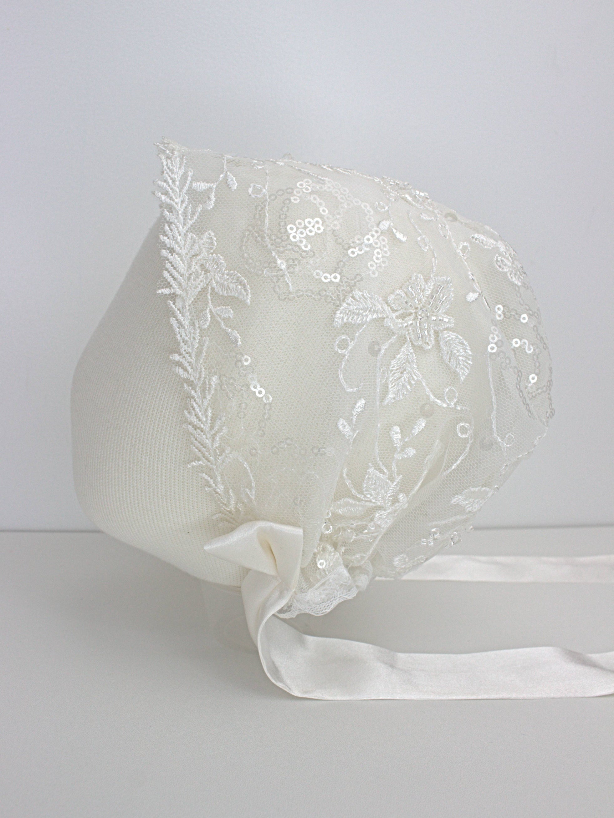 My Blessing Eternal ivory baby christening bonnet from the Eternal set with lace embroidery and satin ties.