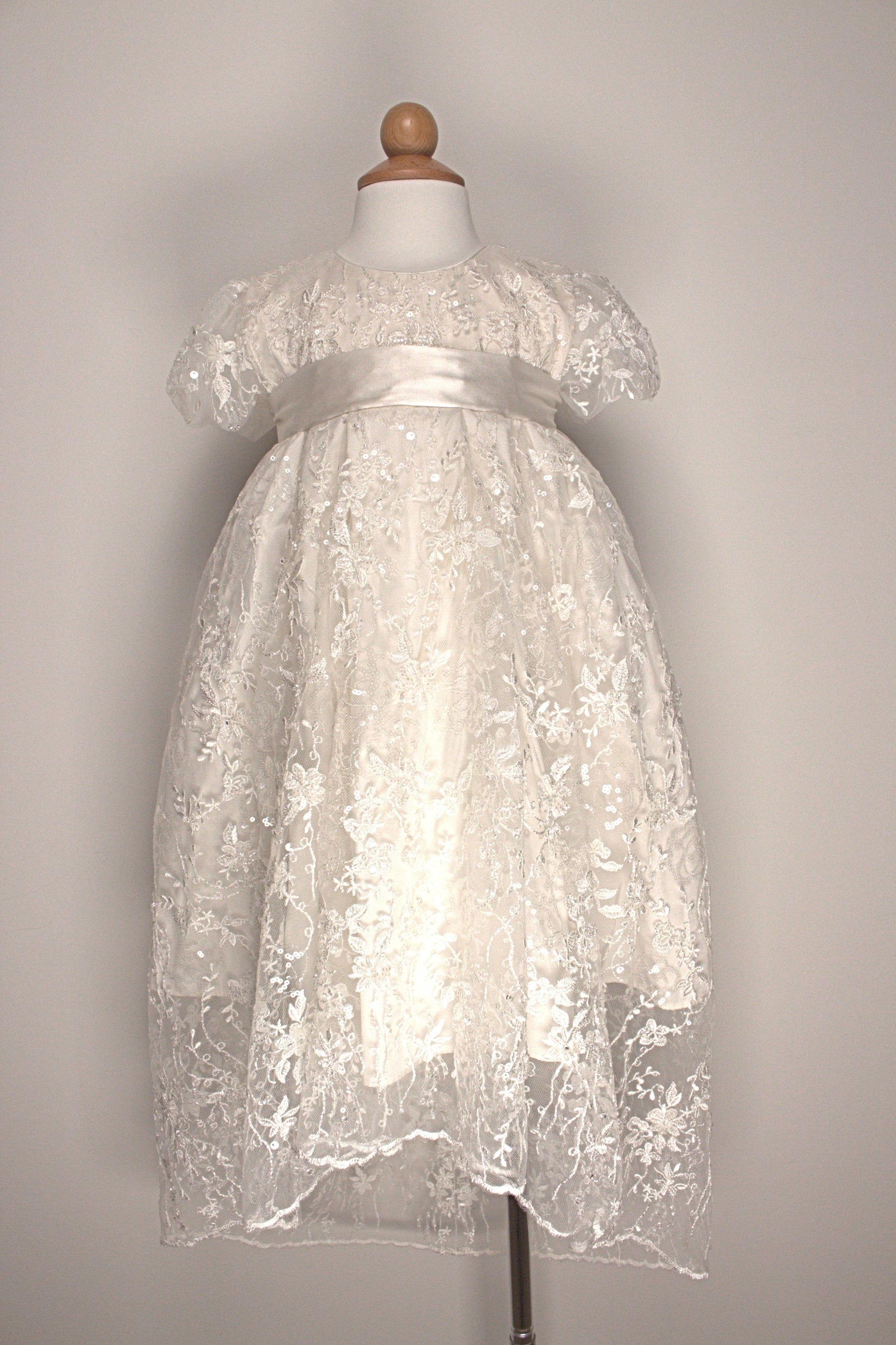My Blessing Eternal ivory christening gown set featuring an embroidered lace bodice, short sleeves, and a flowing satin skirt.