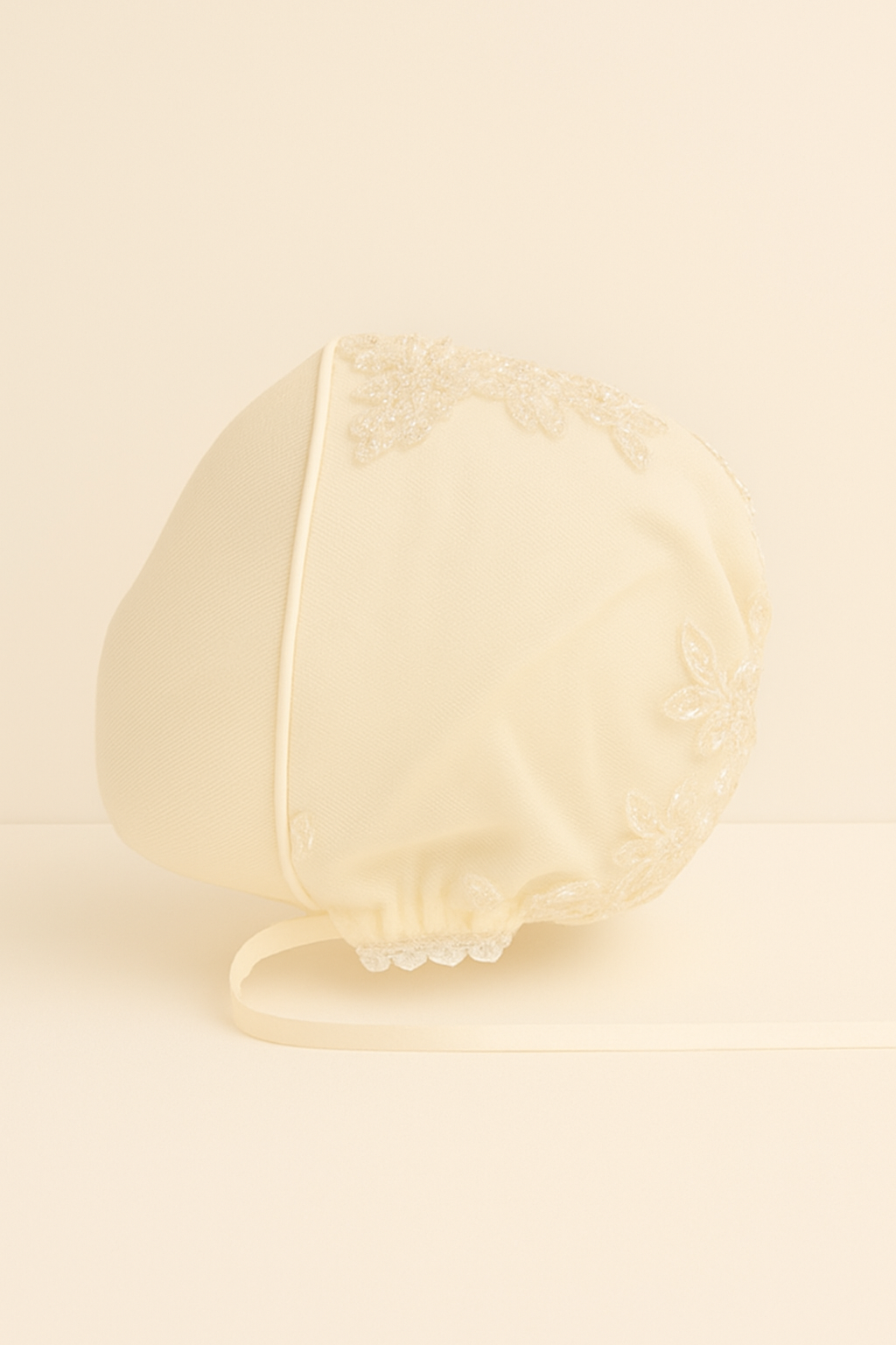 My Blessing ivory christening bonnet from the Fruitful set with embroidered lace and embellishments of reflective sequins and glass seed beads.