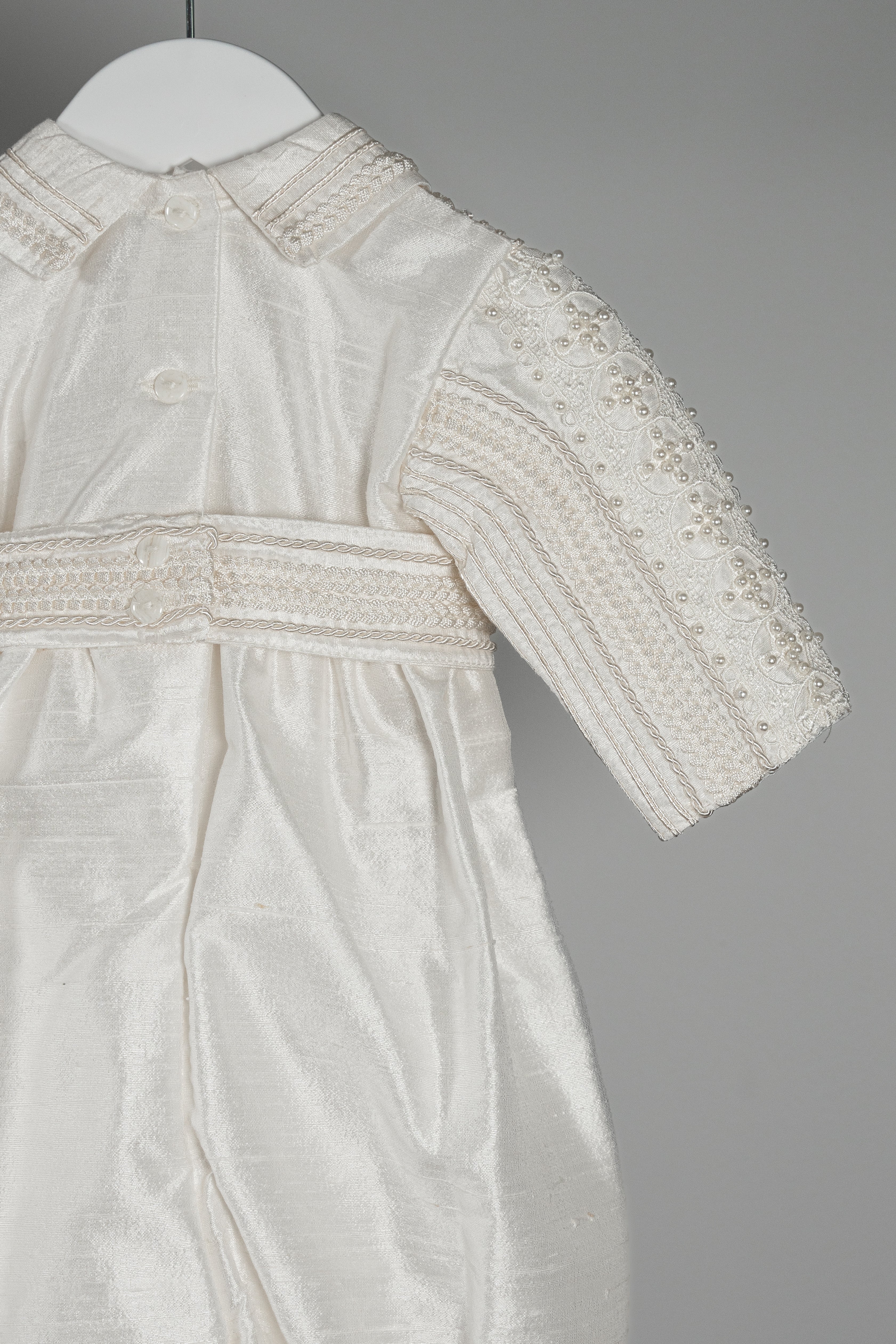Back view of the My Blessing Gabriel romper displaying the natural drape and sheen of pure Dupioni silk.