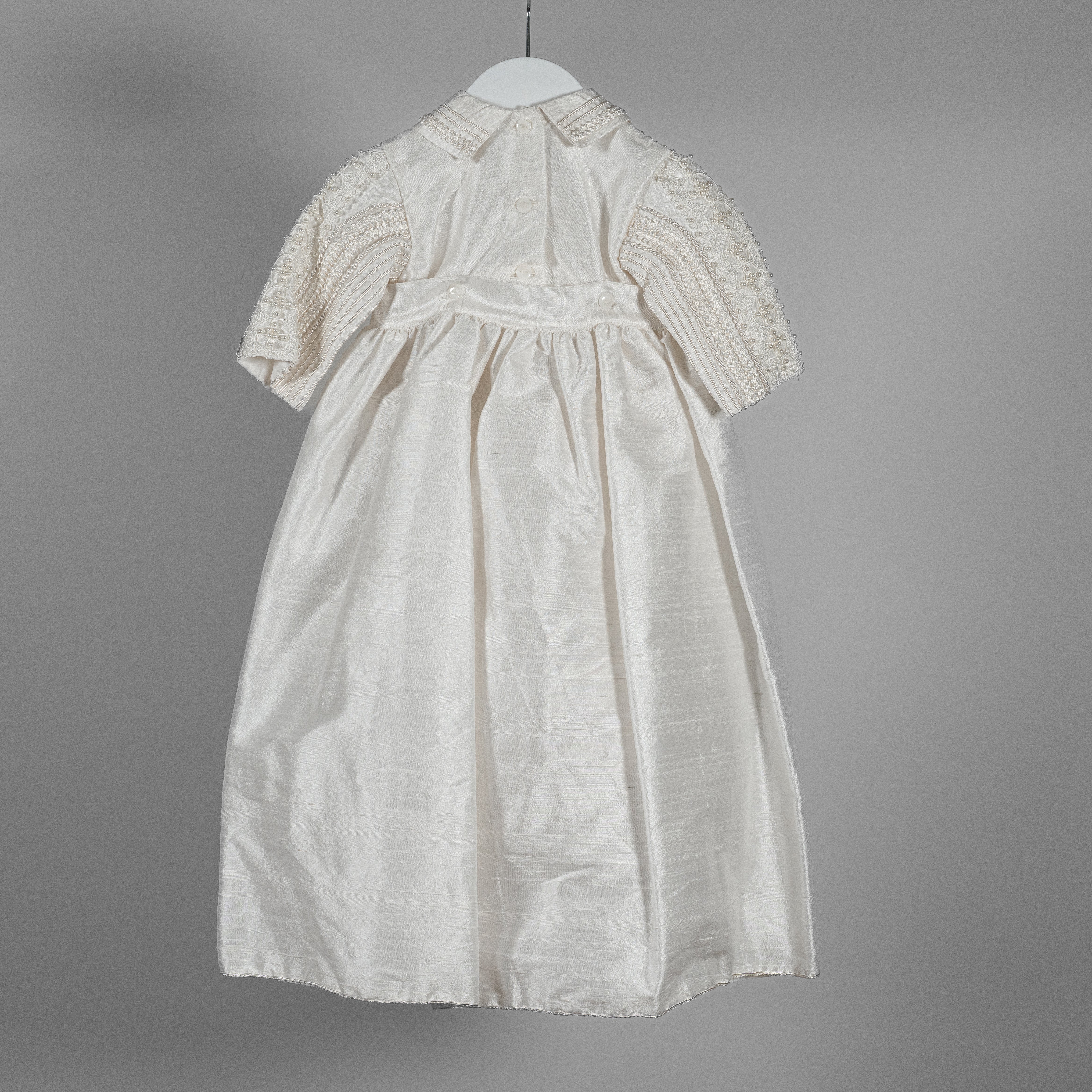 Back view of the My Blessing Gabriel baptism romper featuring smooth Dupioni silk and shuttle lace accents along the collar and sleeves.
