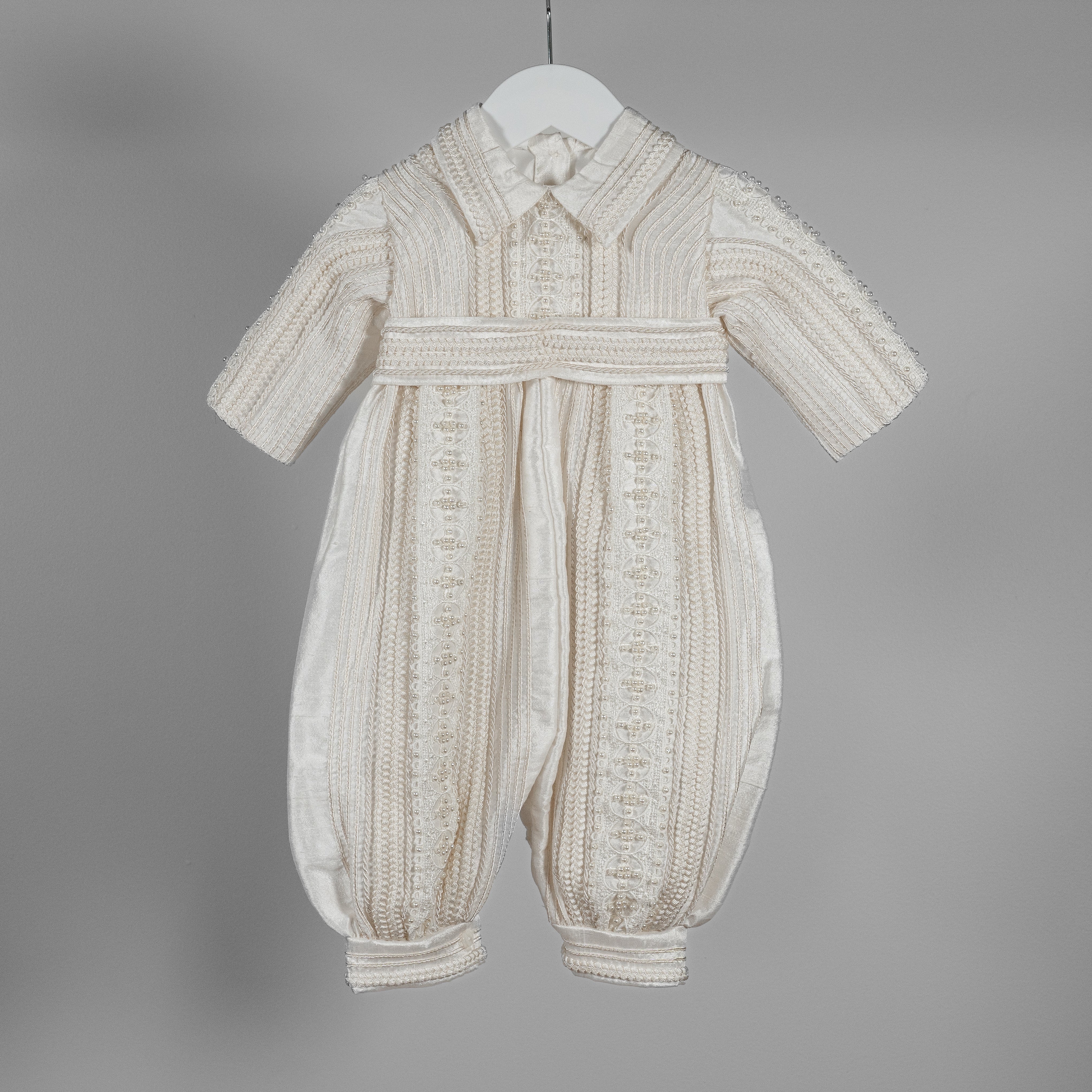 Close-up of the My Blessing Gabriel silk romper showing miniature hand‑placed pearls and delicate woven lace accents.