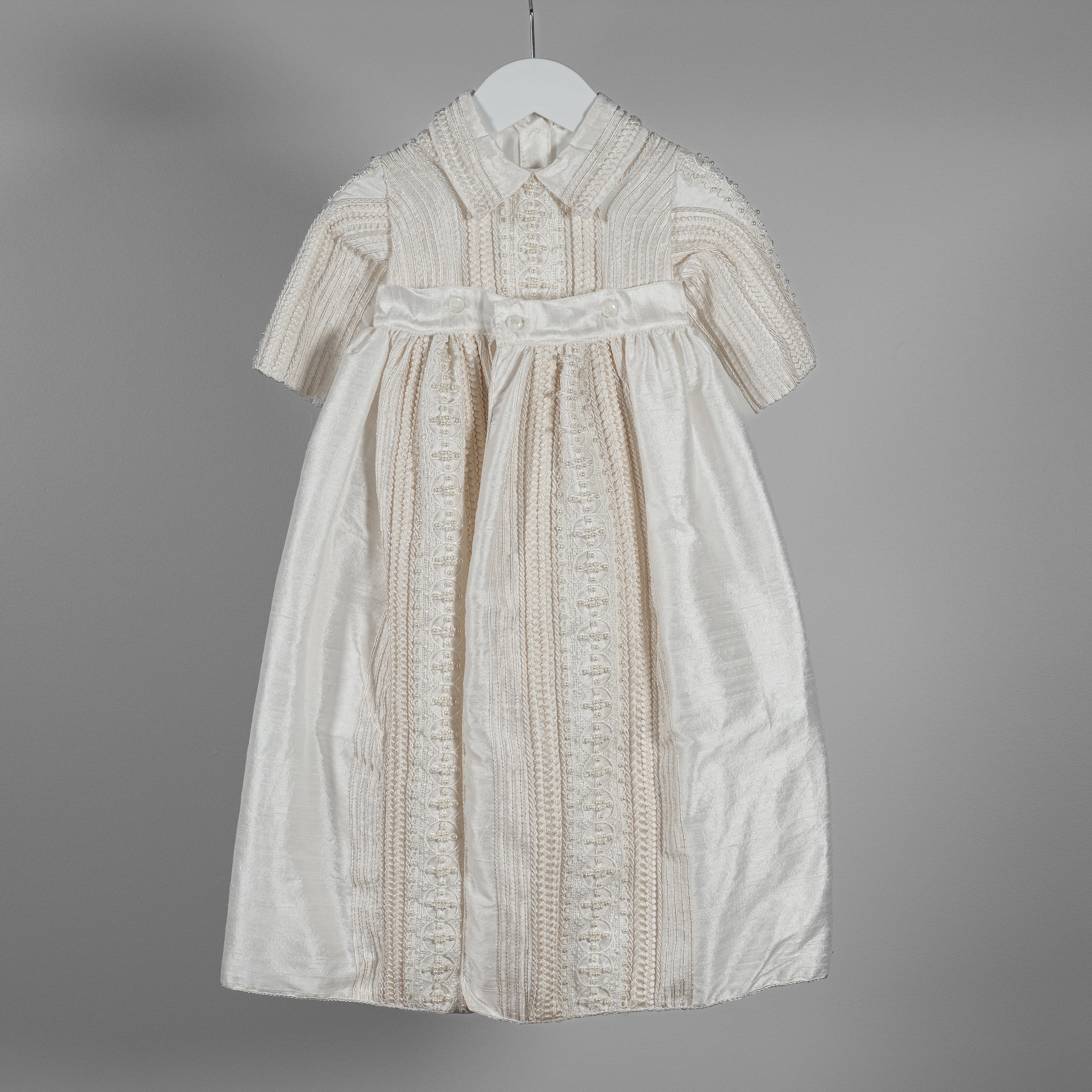 My Blessing ivory Gabriel baptism romper crafted from 100% Dupioni silk with hand‑finished pearl detailing and woven lace trimming across the chest.