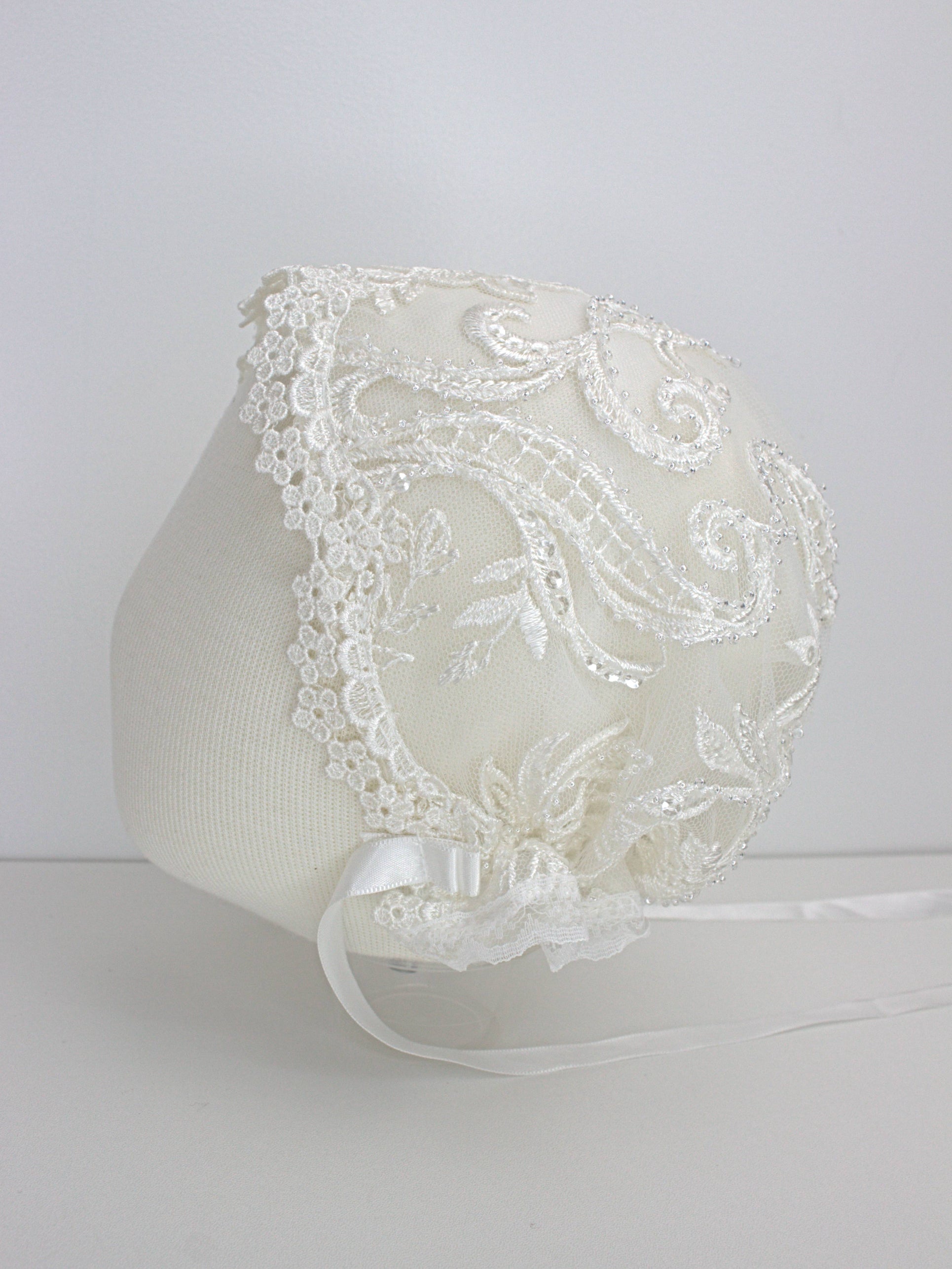 My Blessing Glorious ivory christening bonnet with lace embroidery and satin ties.