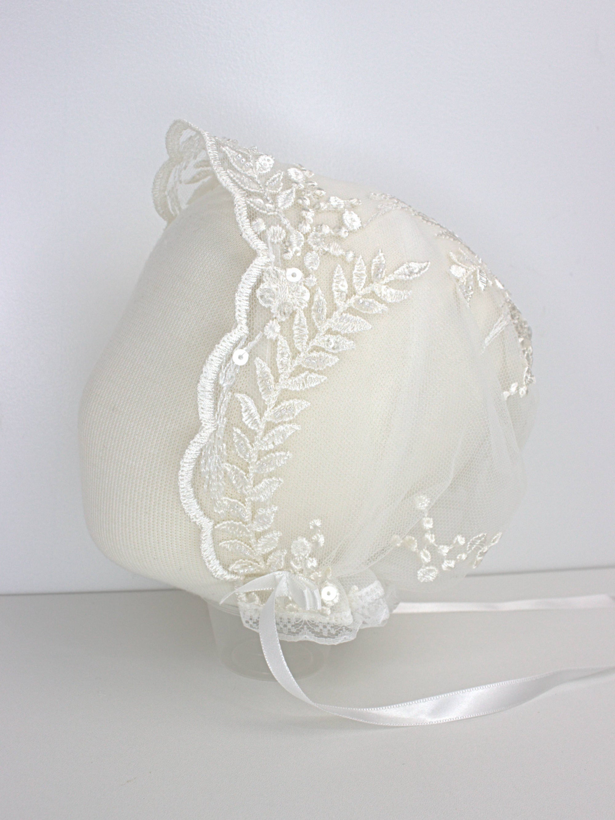 My Blessing ivory christening bonnet from the Grateful set with lace embroidery and satin ties.