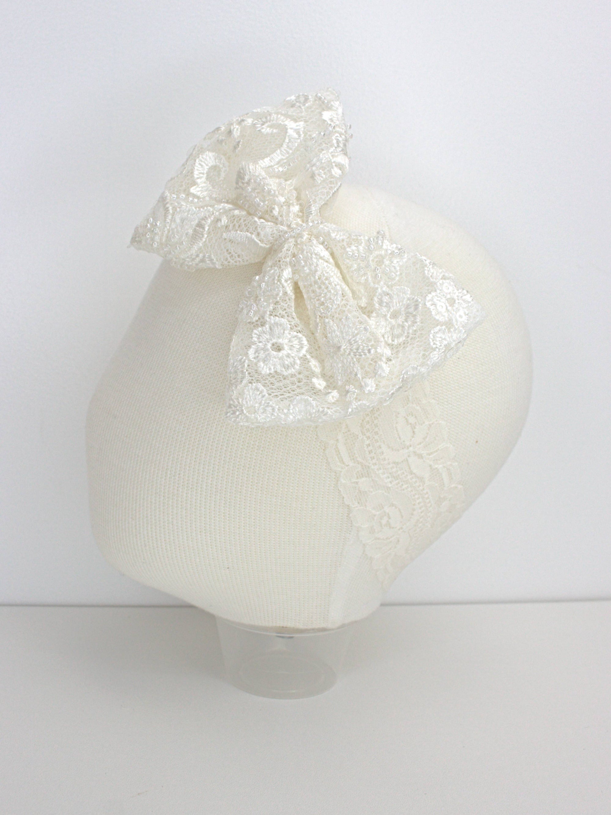 My Blessing ivory baby headband with a lace flower embellishment from the Grateful christening set.