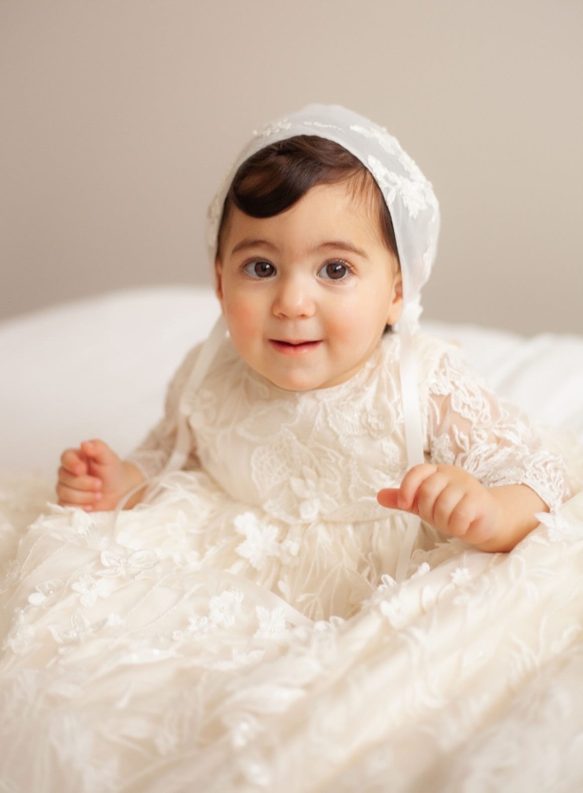 Close-up of the My Blessing Humble christening gown showing the intricate European lace embroidery embellished with delicate baby pearls, glass seed beads, and subtle reflective sequins.