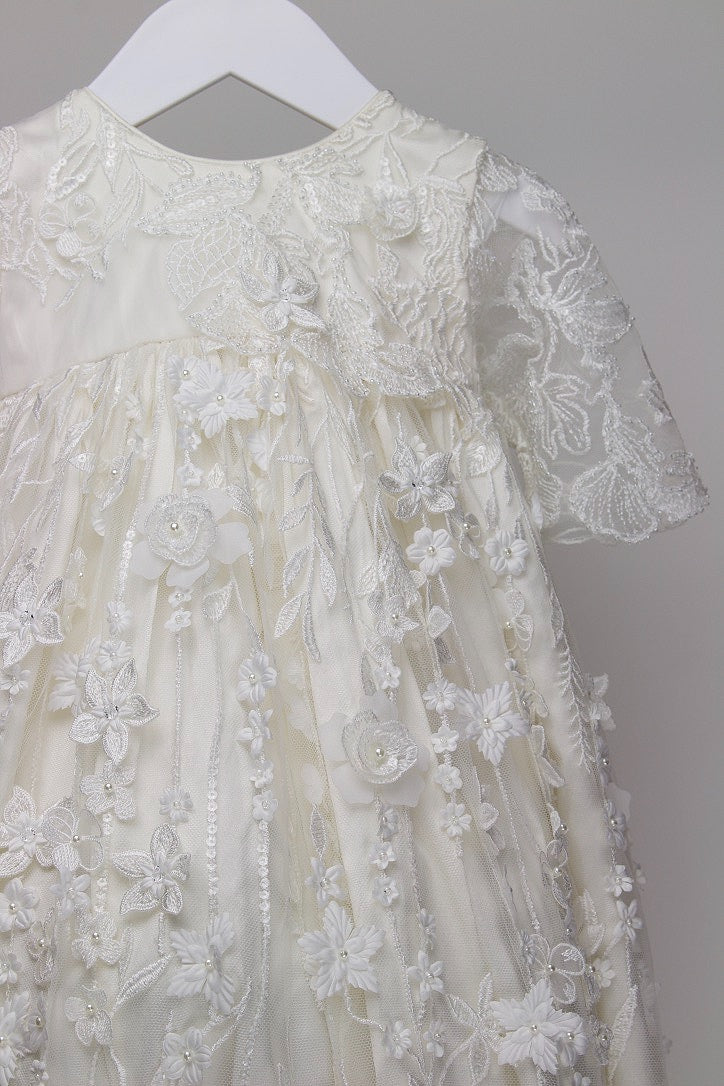 Close-up of the My Blessing Humble christening gown showing the intricate European lace embroidery embellished with delicate baby pearls, glass seed beads, and subtle reflective sequins.