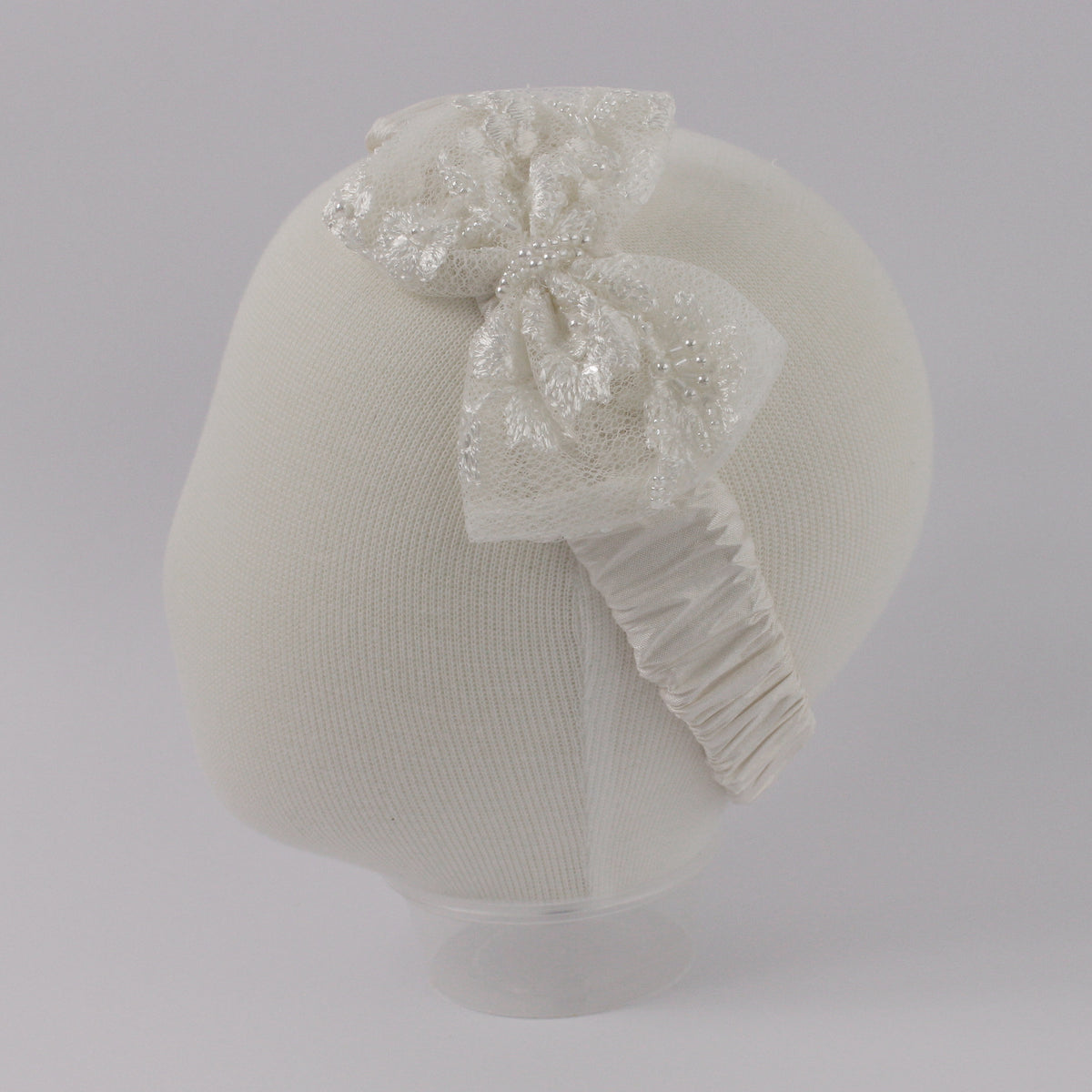 My Blessing ivory baby headband from the Humble set featuring a European lace floral centerpiece with pearls, beads, and soft sequins.