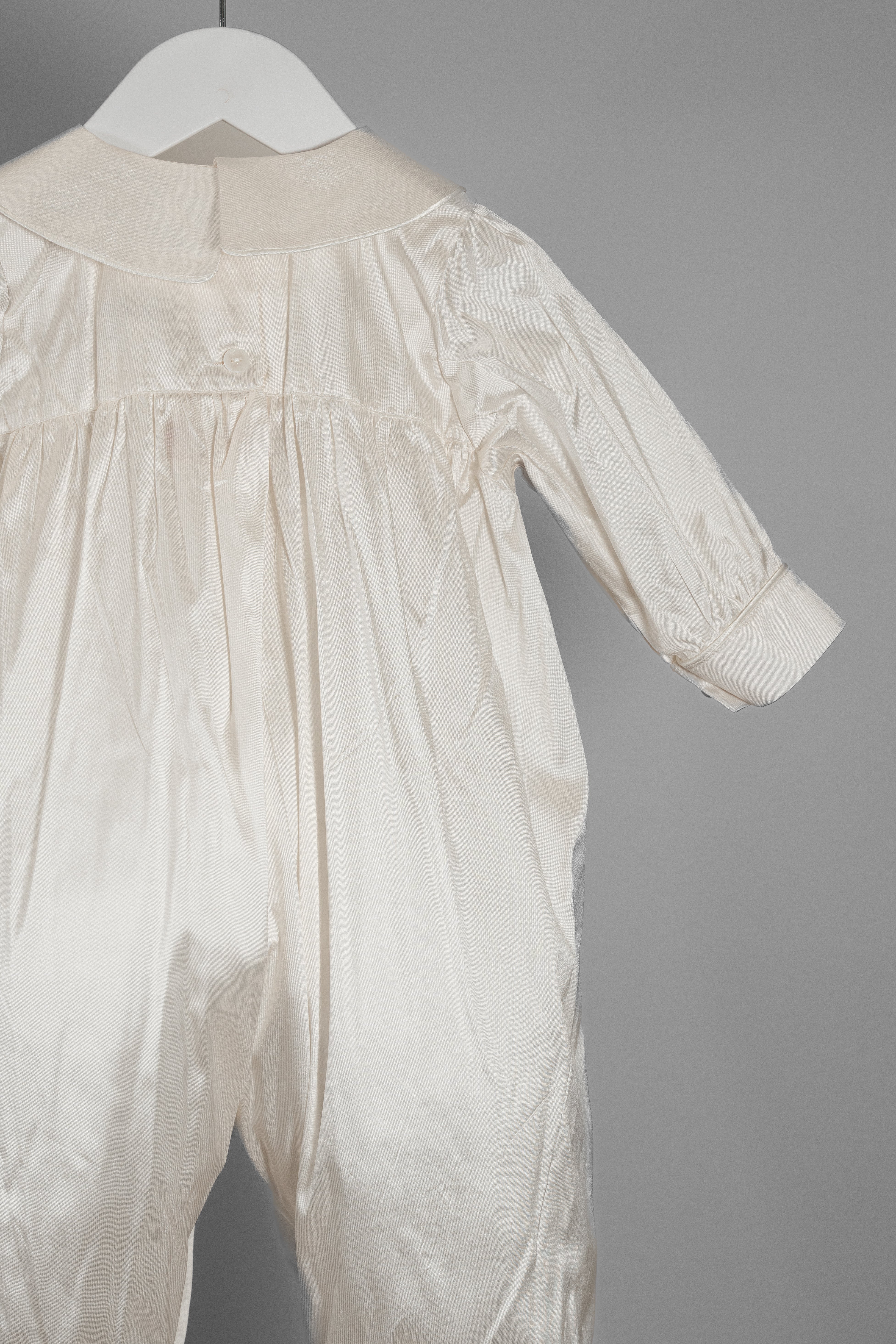 Close-up of the My Blessing Lael romper’s back bodice showing the structured silk finish and clean, traditional construction.
