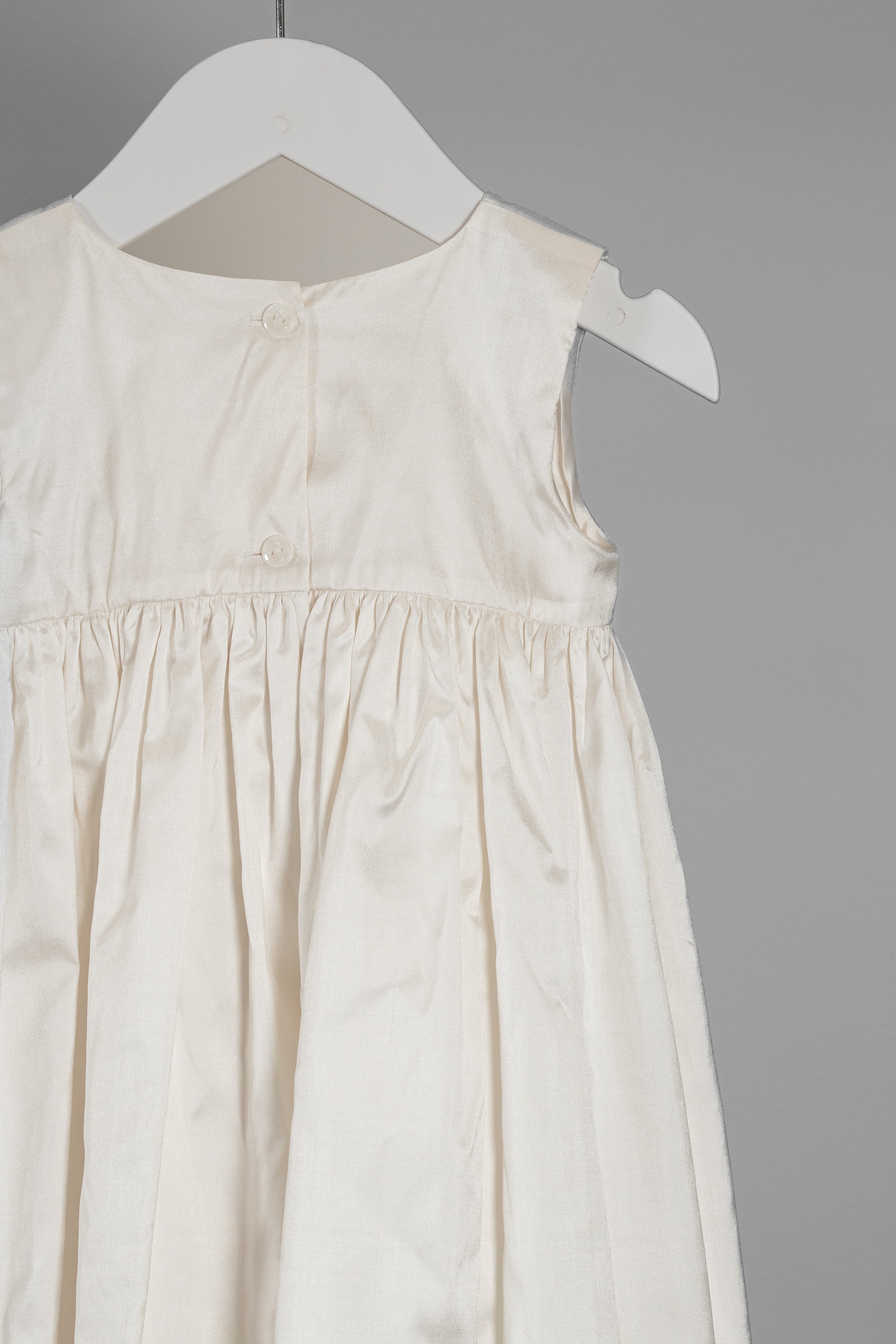 Close-up of the My Blessing Lael cape showing the smooth Dupioni silk texture and refined stitching.