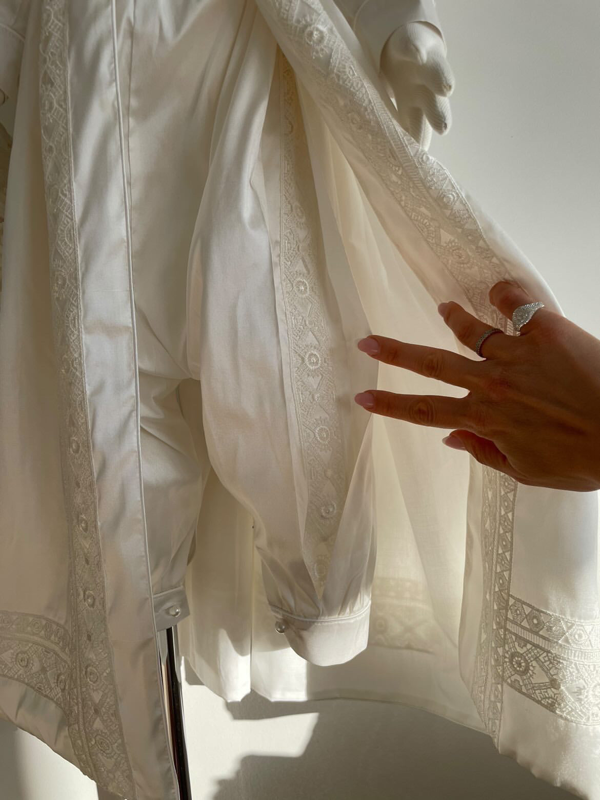 Close-up of the My Blessing Lael romper’s ivory lace detailing across the bodice and leg inserts.