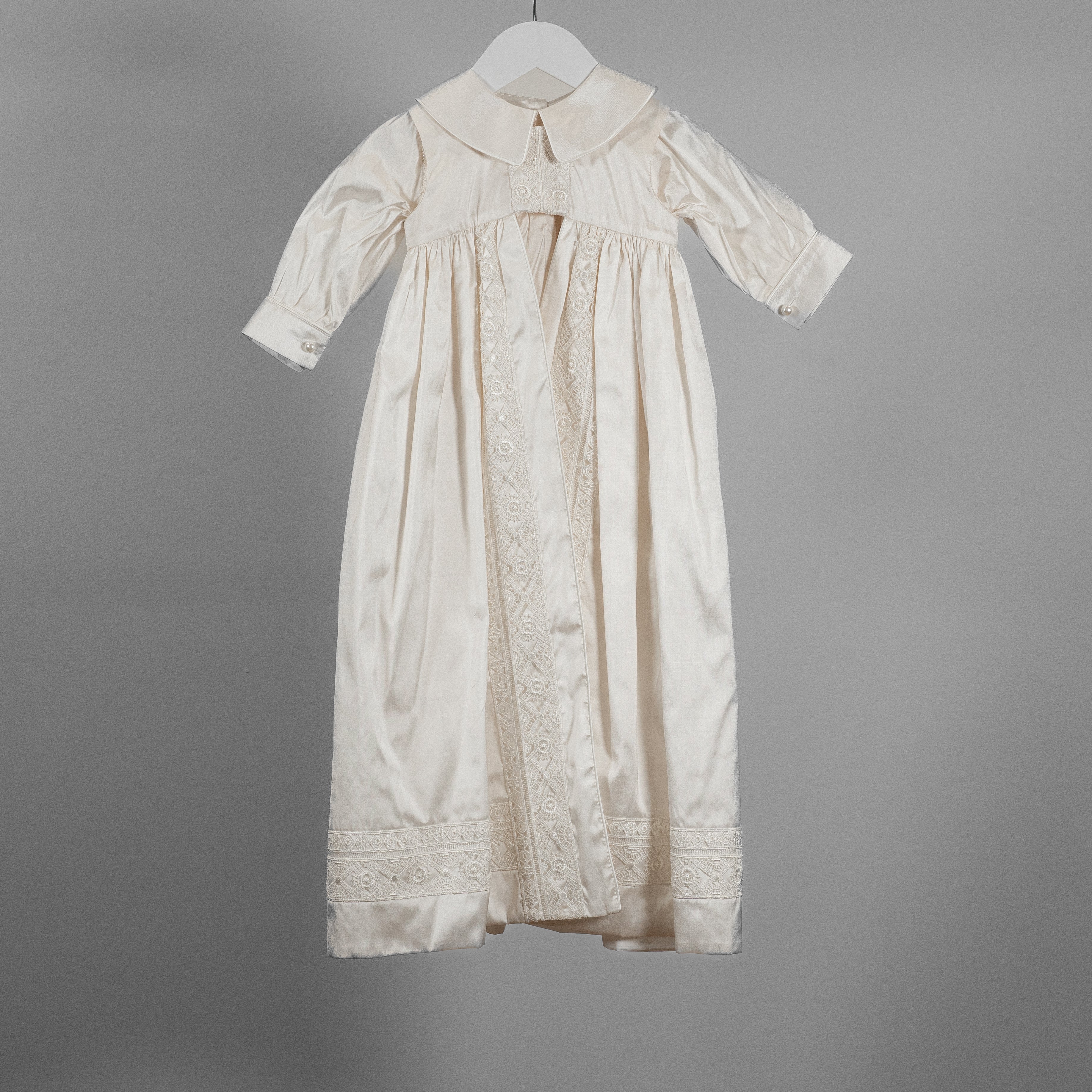 My Blessing ivory Lael baptism romper crafted from 100% pure Dupioni silk with delicate lace detailing across the bodice and leg inserts.