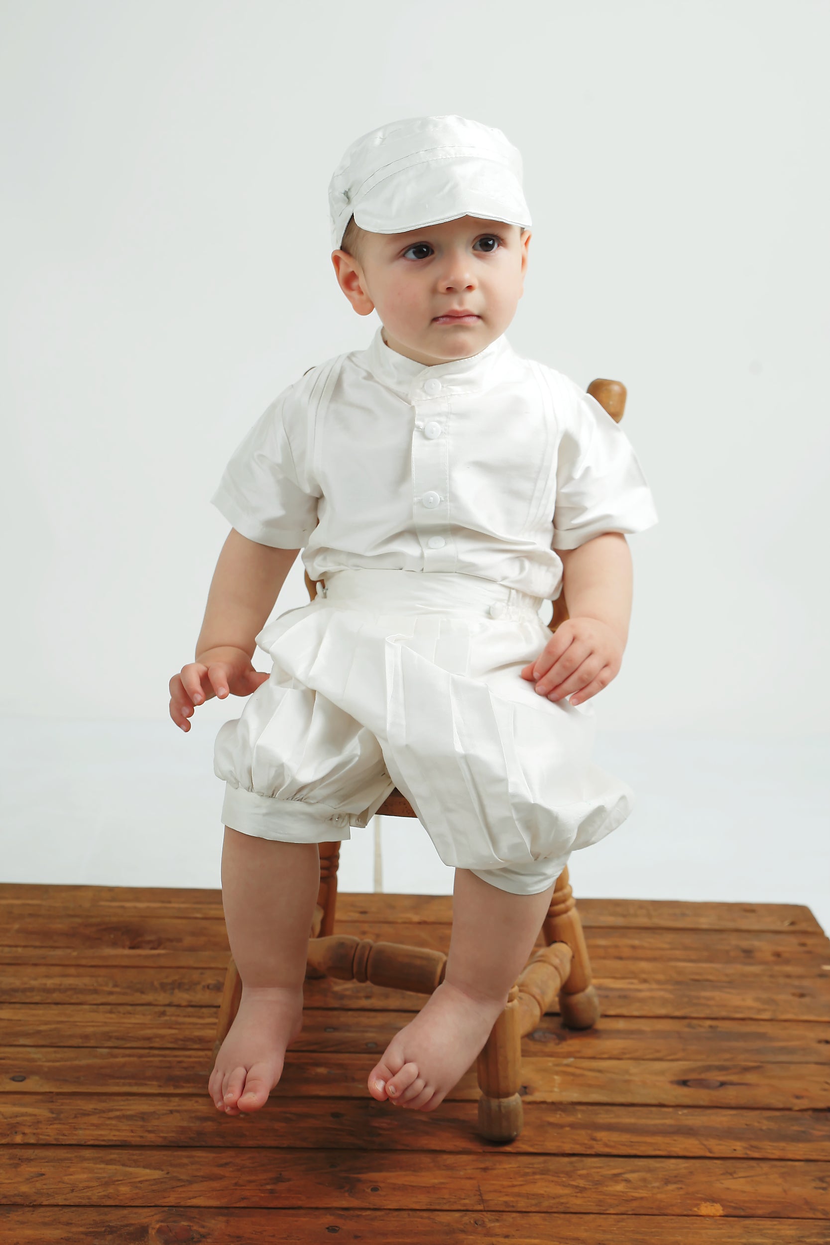 Baby boy wearing the My Blessing Lemuel baptism set with matching silk ivy cap, creating a classic gentleman look.