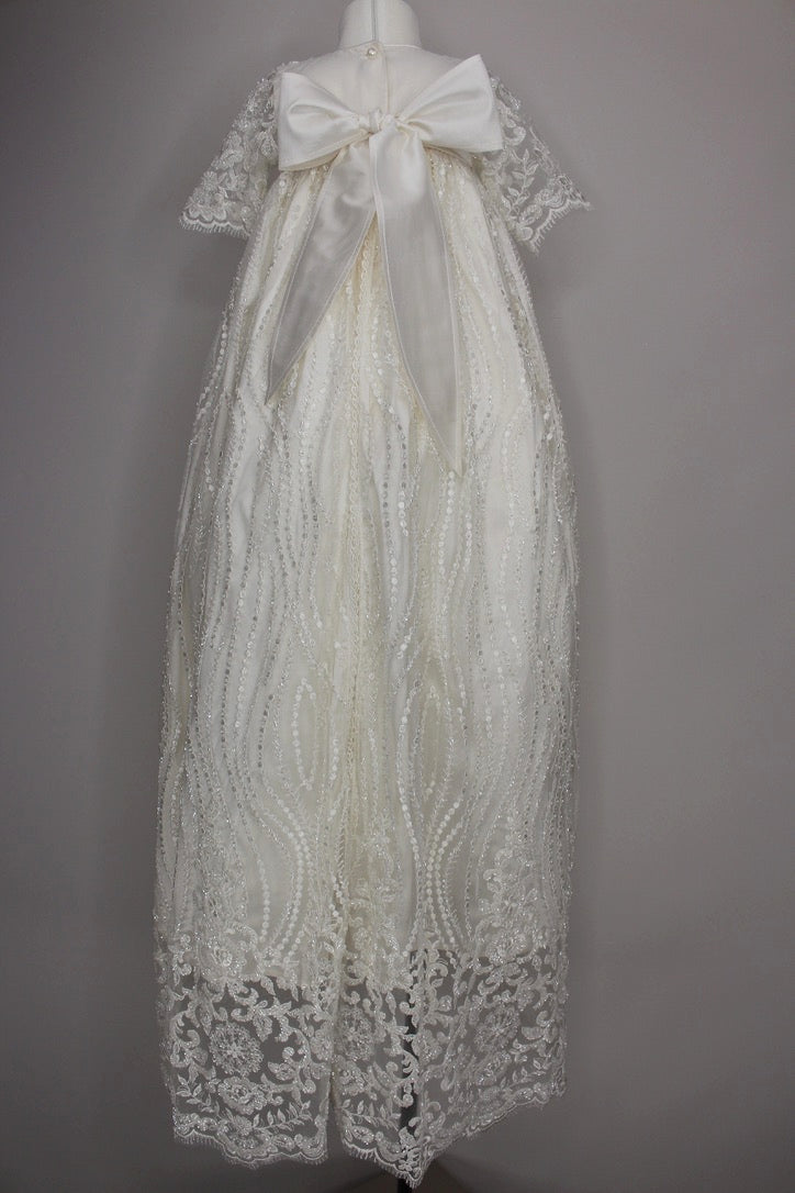 Back view of the My Blessing Nineveh ivory christening gown showing lace detailing, back closures, and the soft silk‑underlay skirt.