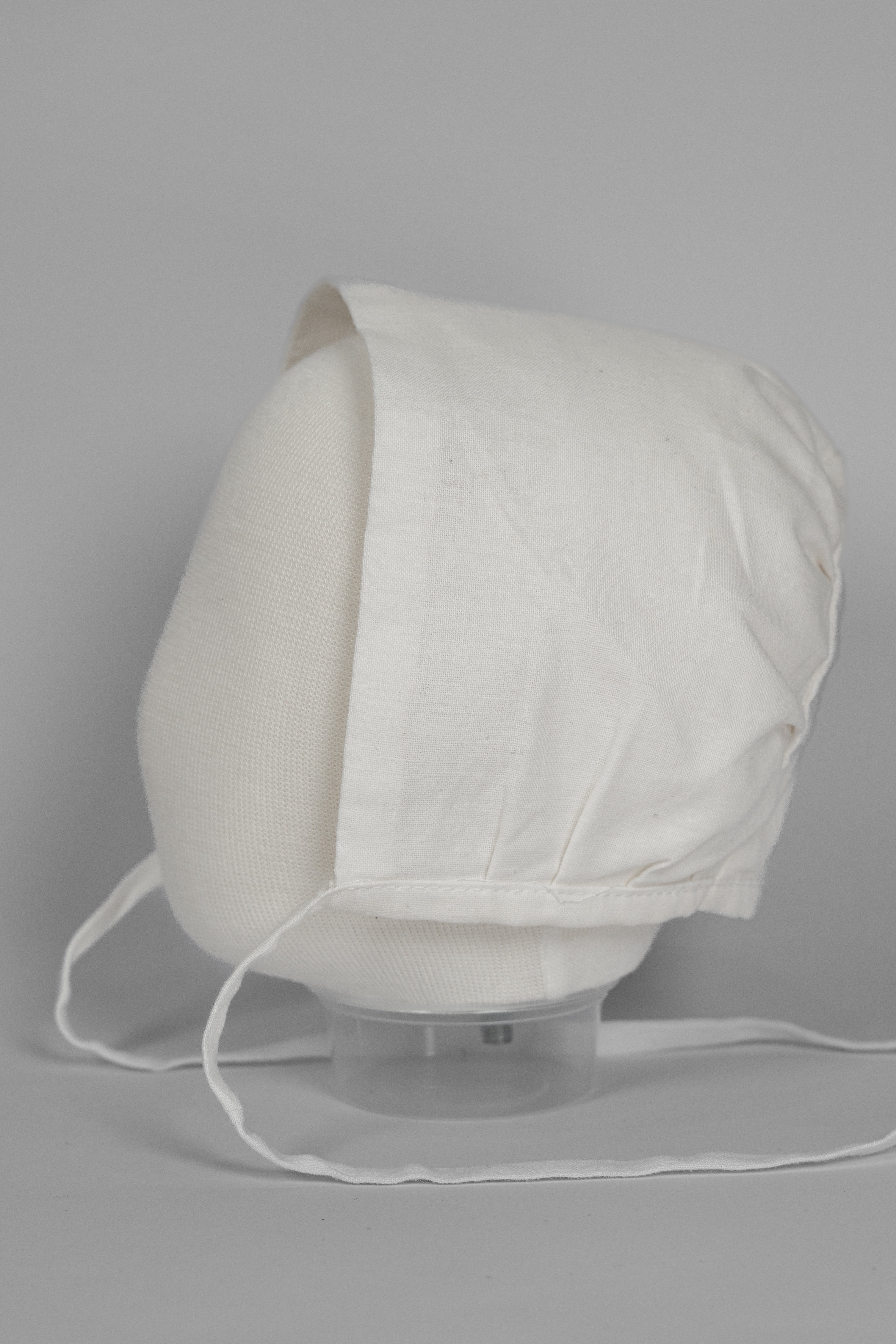 My Blessing ivory linen christening bonnet from the Noa set featuring a clean, minimalist design.