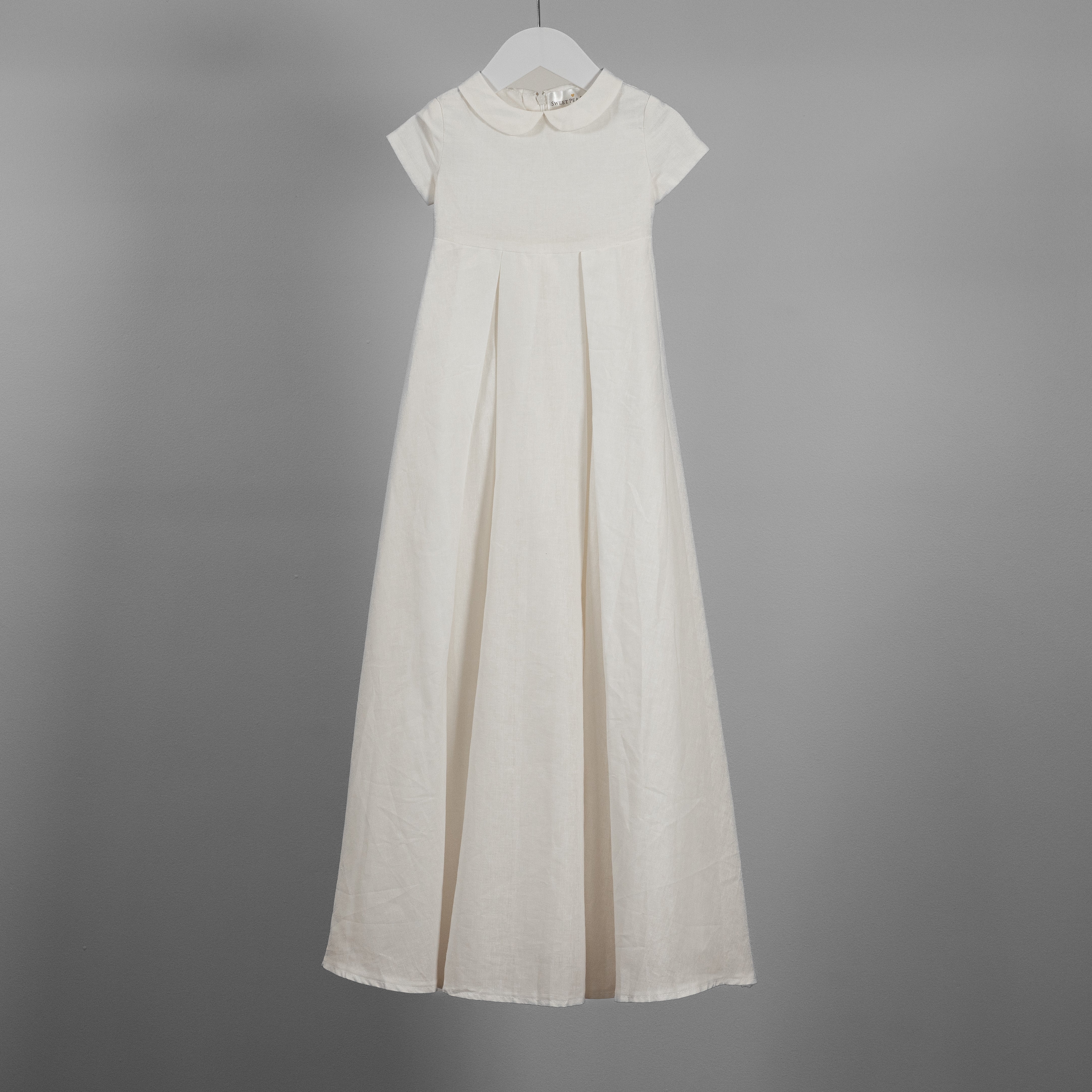 My Blessing ivory full‑length Noa christening gown made from soft premium linen, featuring a classic Peter Pan collar and two front pleats.