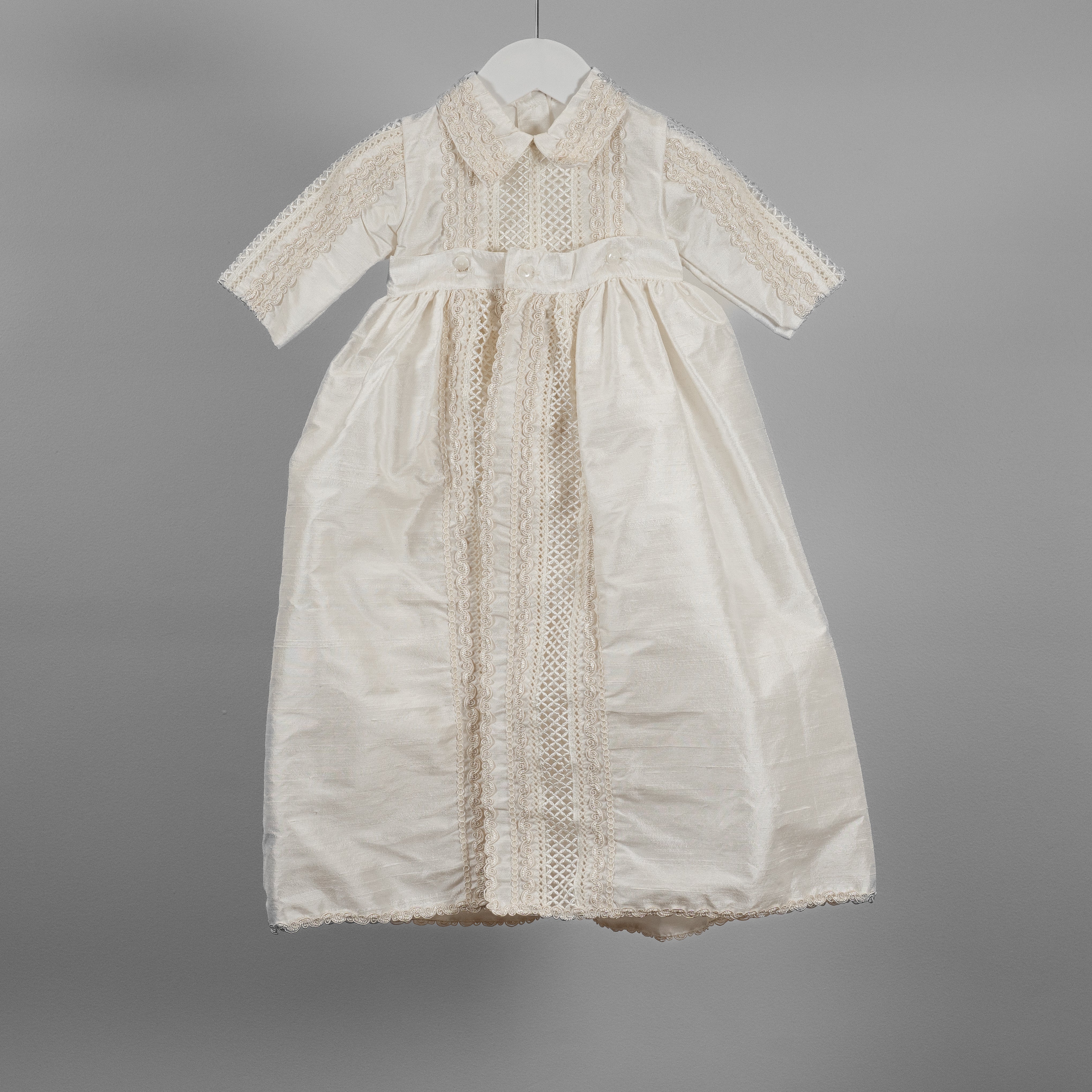 My Blessing ivory Dupioni silk Noah baptism romper featuring shuttle lace detailing across the collar, chest, and sleeves.