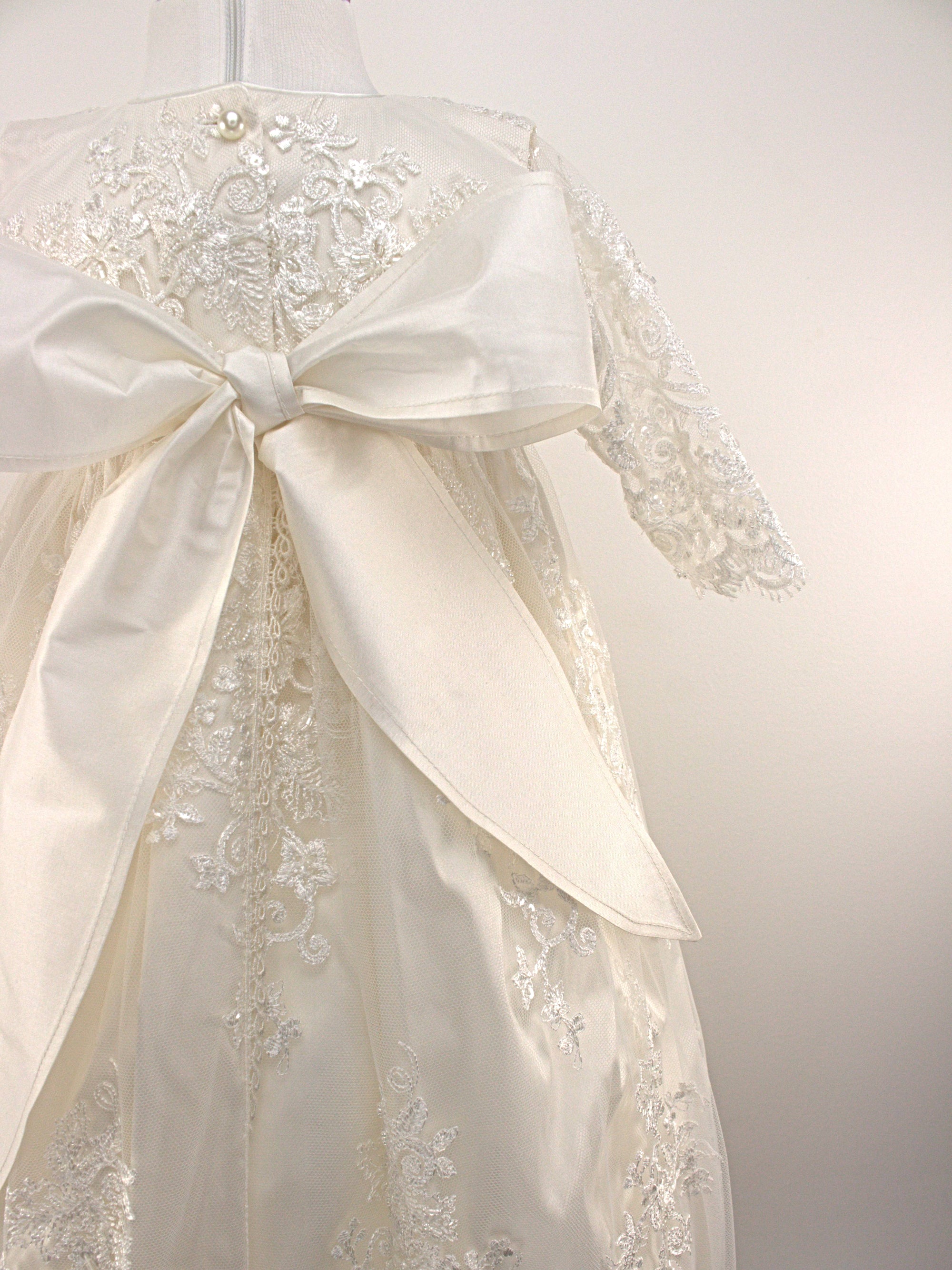 Close-up of My Blessing Noble gown’s back bodice featuring delicate lace patterns and button or tie closures.