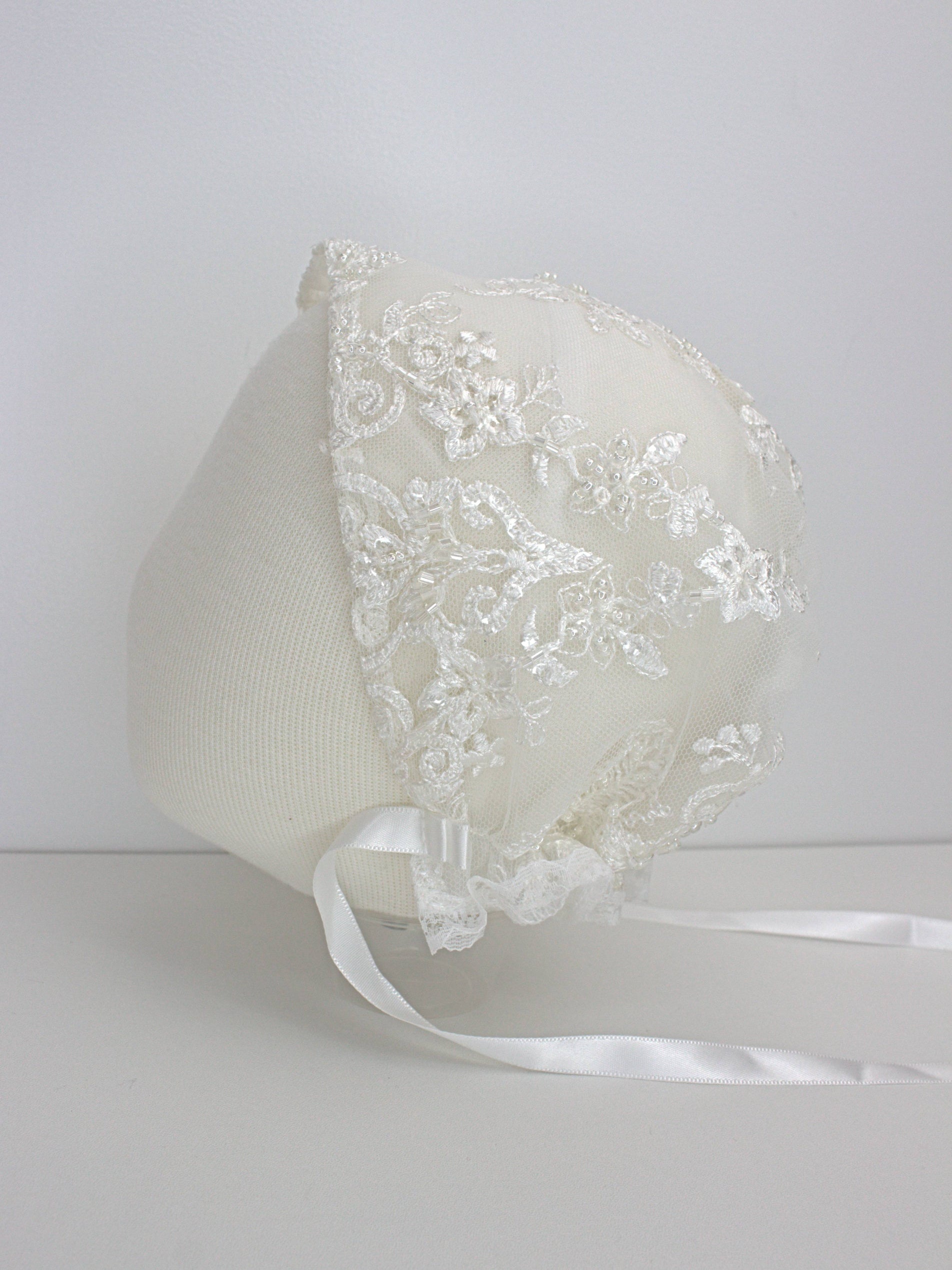 My Blessing Noble ivory christening bonnet from the Noble set with lace embroidery and satin ties.