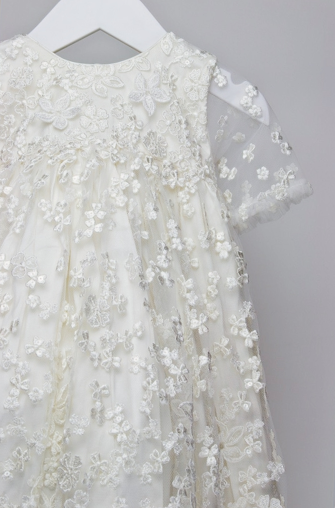 Close-up of the My Blessing Promise gown showing the intricate European floral lace embellished with subtle glass seed beads for a soft, elegant shimmer.