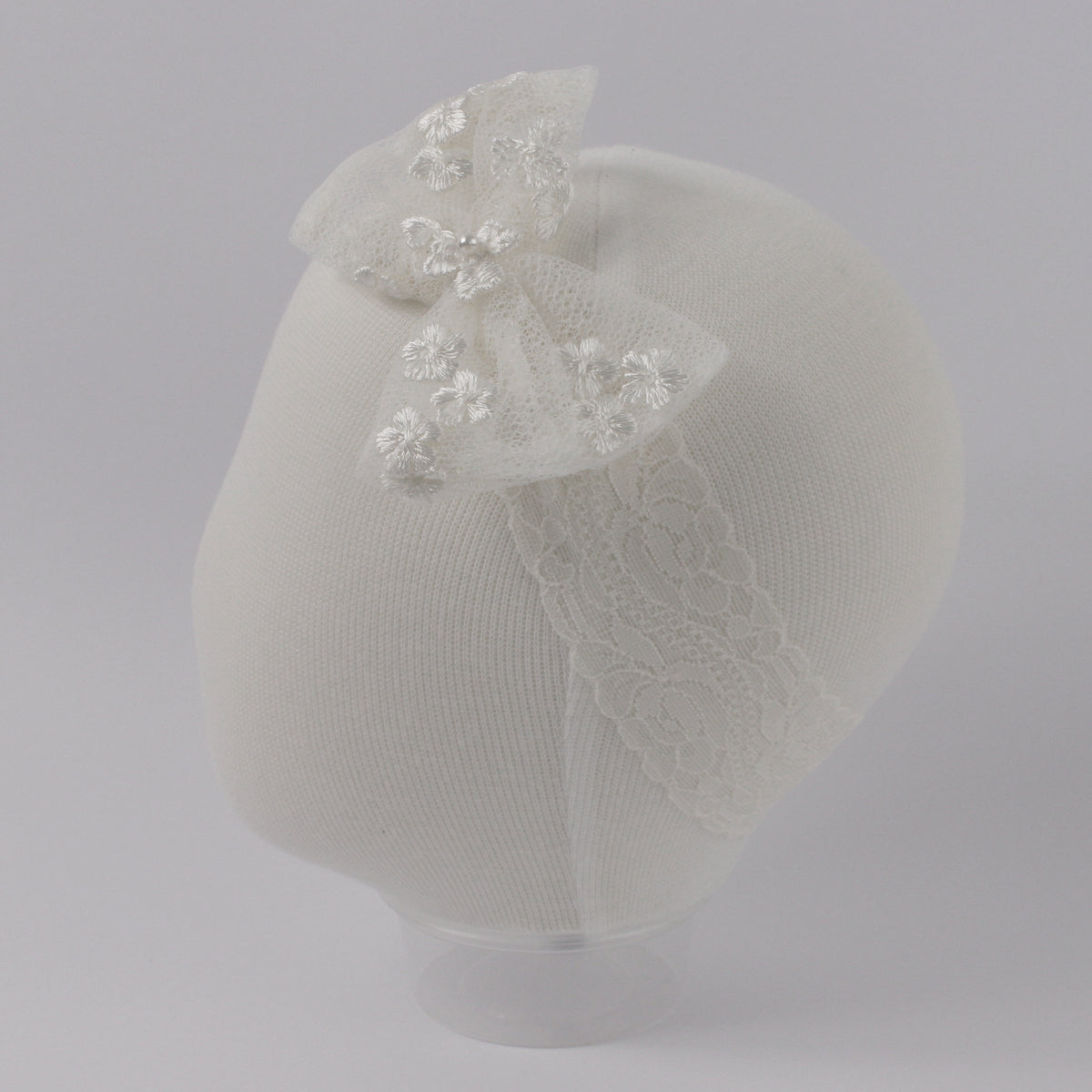 Ivory baby headband from the My Blessing Promise set featuring a lace floral centerpiece with glass seed bead embellishments.