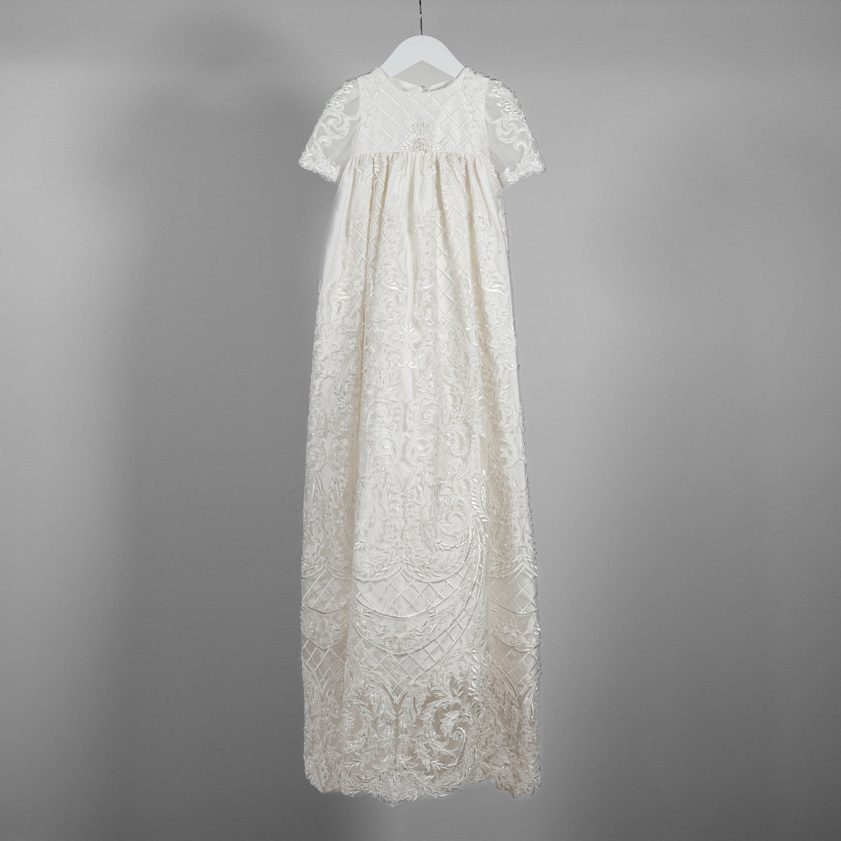My Blessing ivory christening gown from the Psalms set featuring an embroidered lace bodice adorned with glass seed beads and pearl detailing.