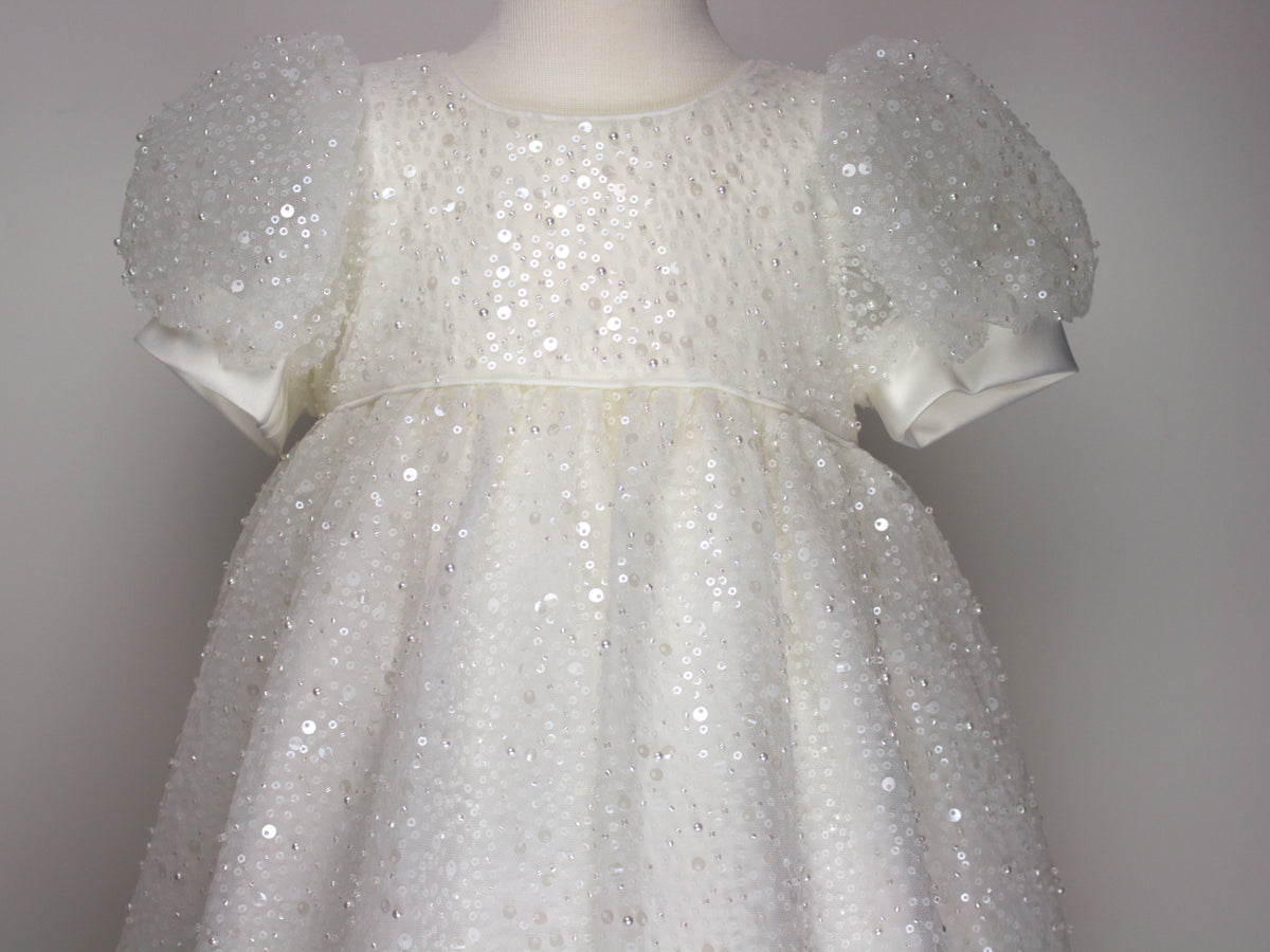 Close-up of the My Blessing Ruth christening dress’s front bodice showing intricate floral lace embroidery embellished with sequins, glass seed beads, and miniature pearls.
