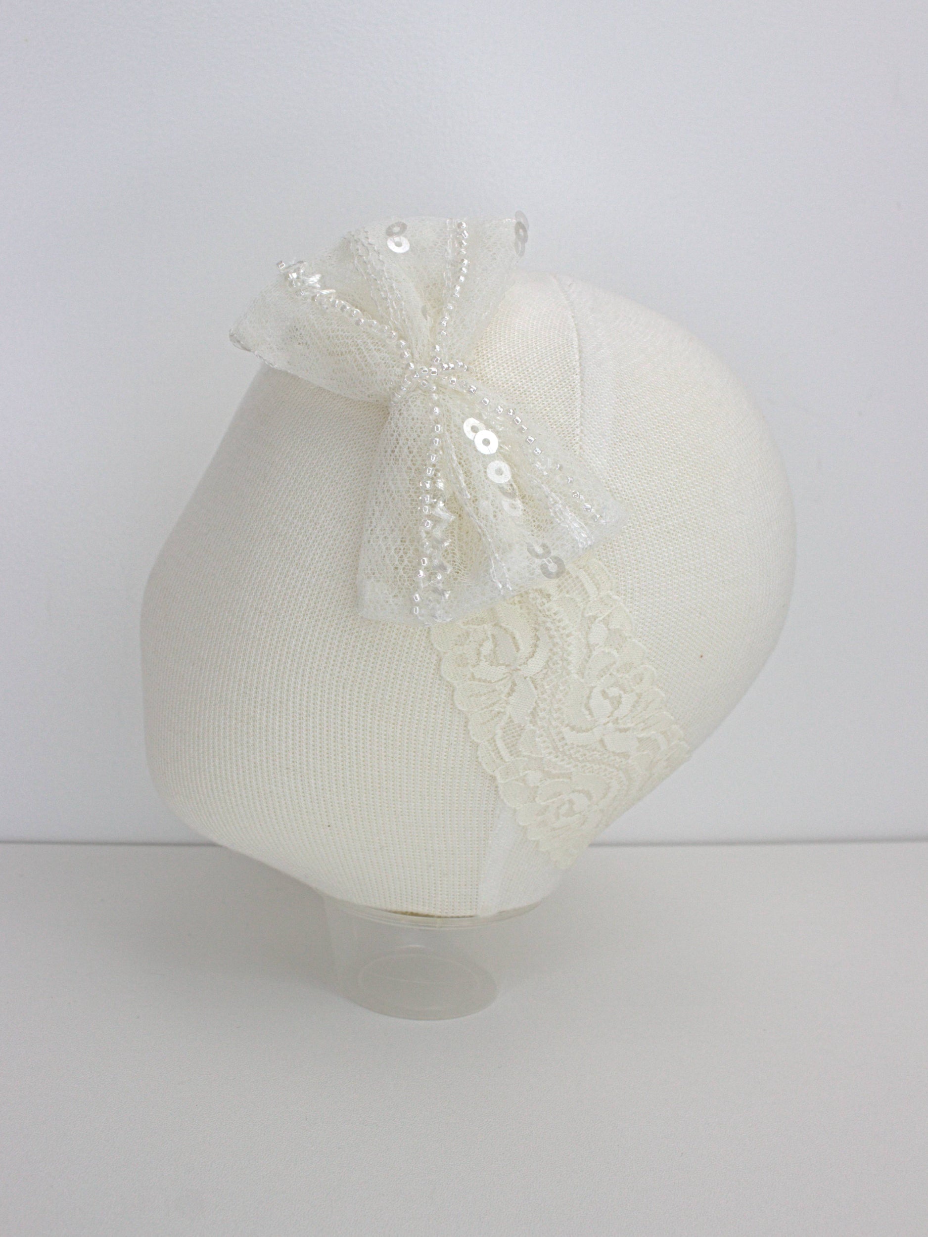 My Blessing Soul ivory baby headband with a lace flower embellishment from the Soul christening set.
